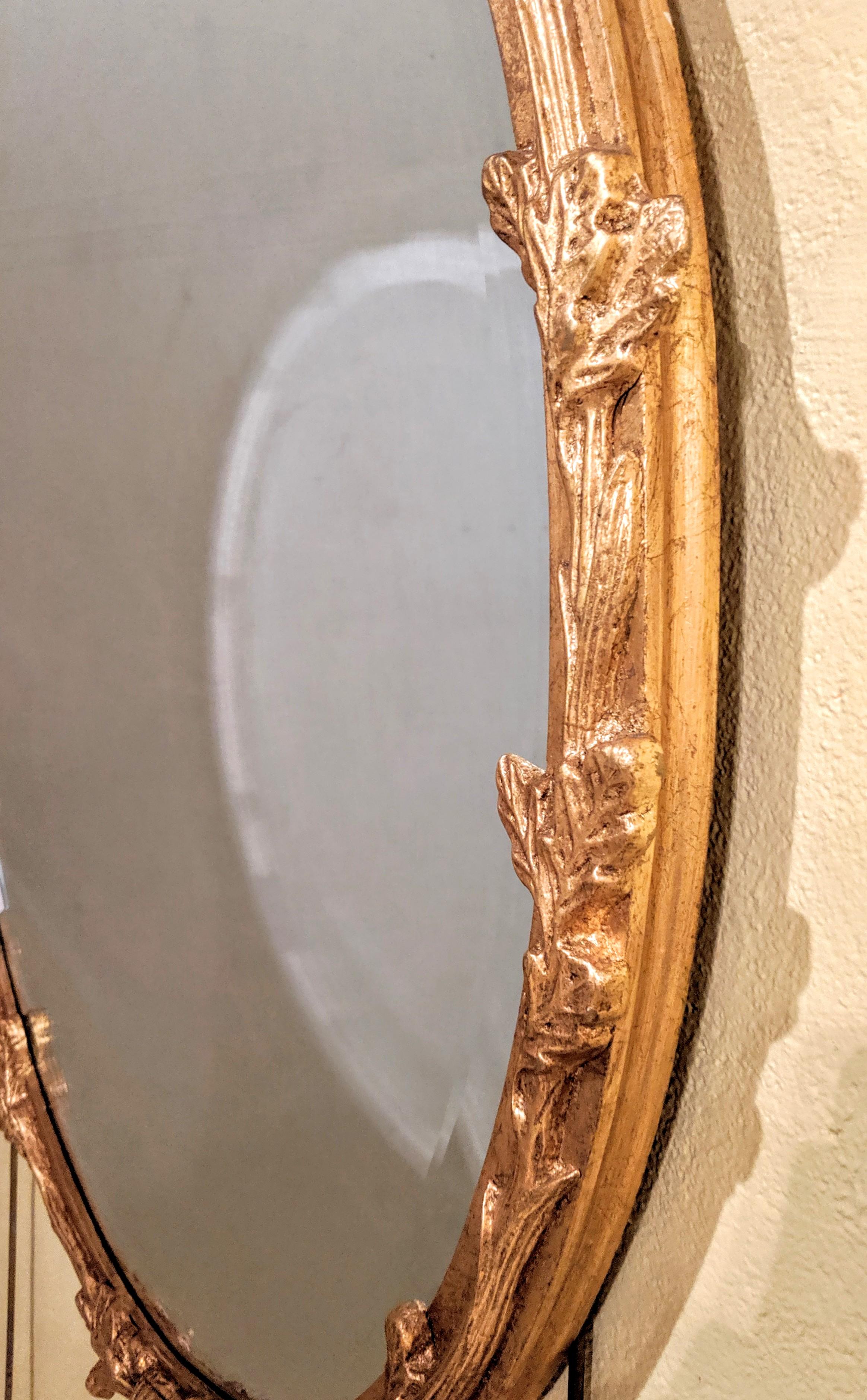 Friedmans wall console or mantel mirror. Giltwood nicely carved wall mirror with oval frame.