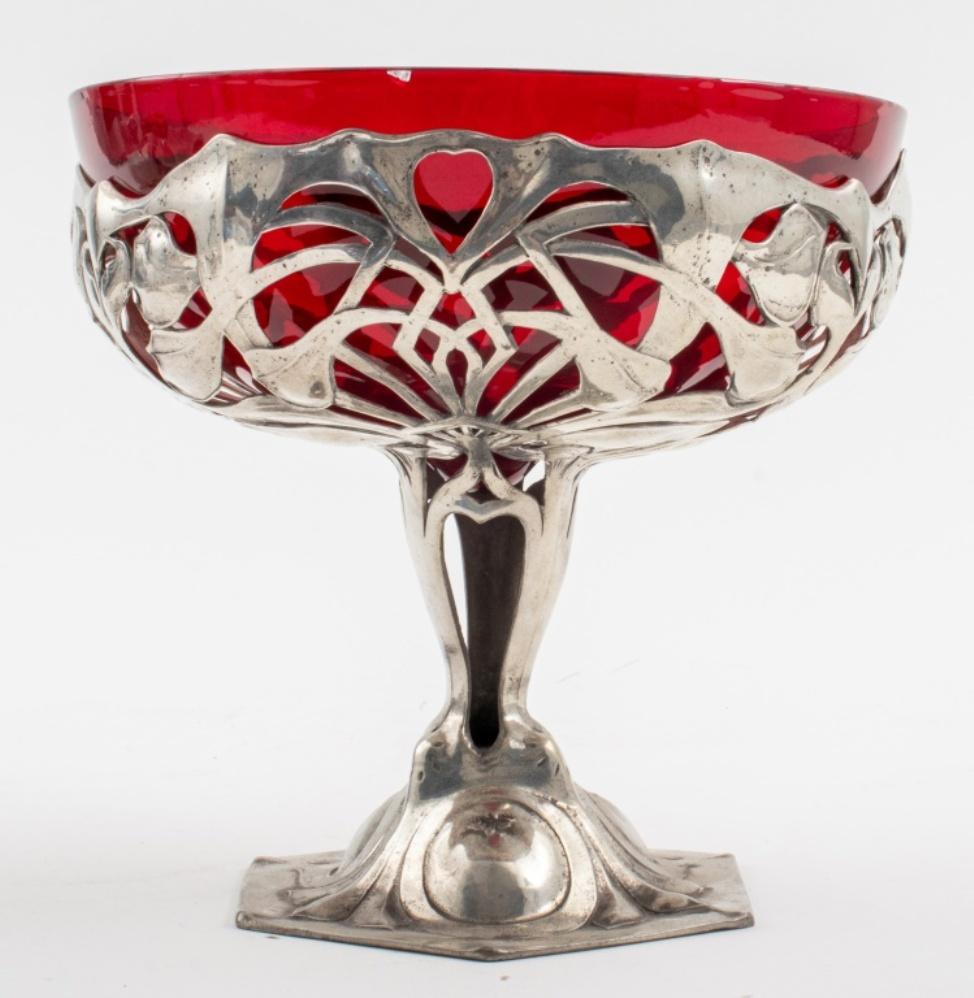 Friedrich Adler for Osiris German Jugendstil pewter and cranberry glass compote or tazza, with mount with openwork foliate design, stamped and numbered underside: 