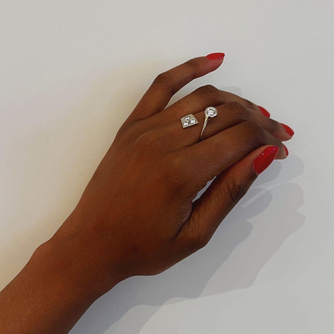 A diamond and 18 karat white gold crossover ring, by German designer Friedrich Becker, 1960s. 

The main diamond is 0.45 ct, K/L, SI and the smaller diamonds ctw. is approximately 0.36 ct, J/K, VS. The ring is a size 6 and stamped 750, maker's mark