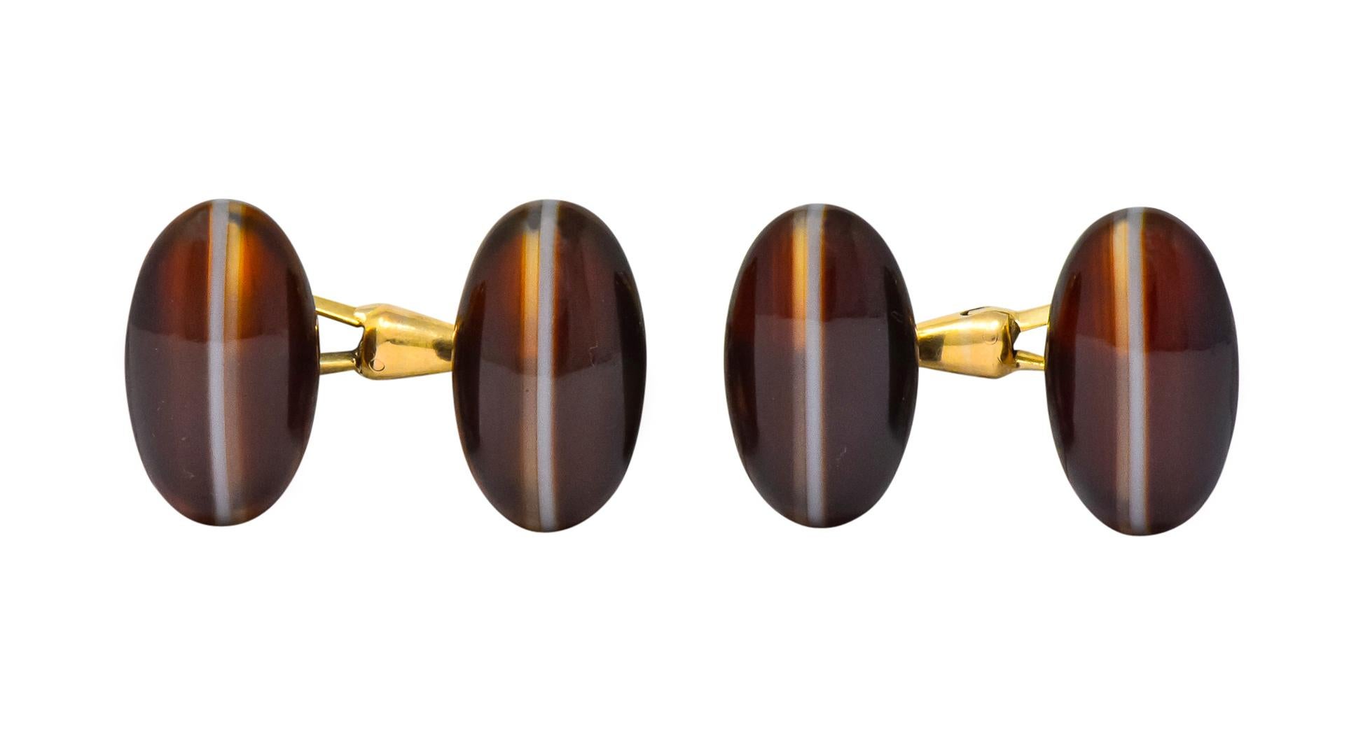 Link style cufflinks set on both ends with an oval cabochon agate measuring approximately 18.3 x 10.7 mm, semi-transparent brown centering an opaque white stripe

With four shirt studs centering a round cabochon agate measuring 6.2 mm, very well