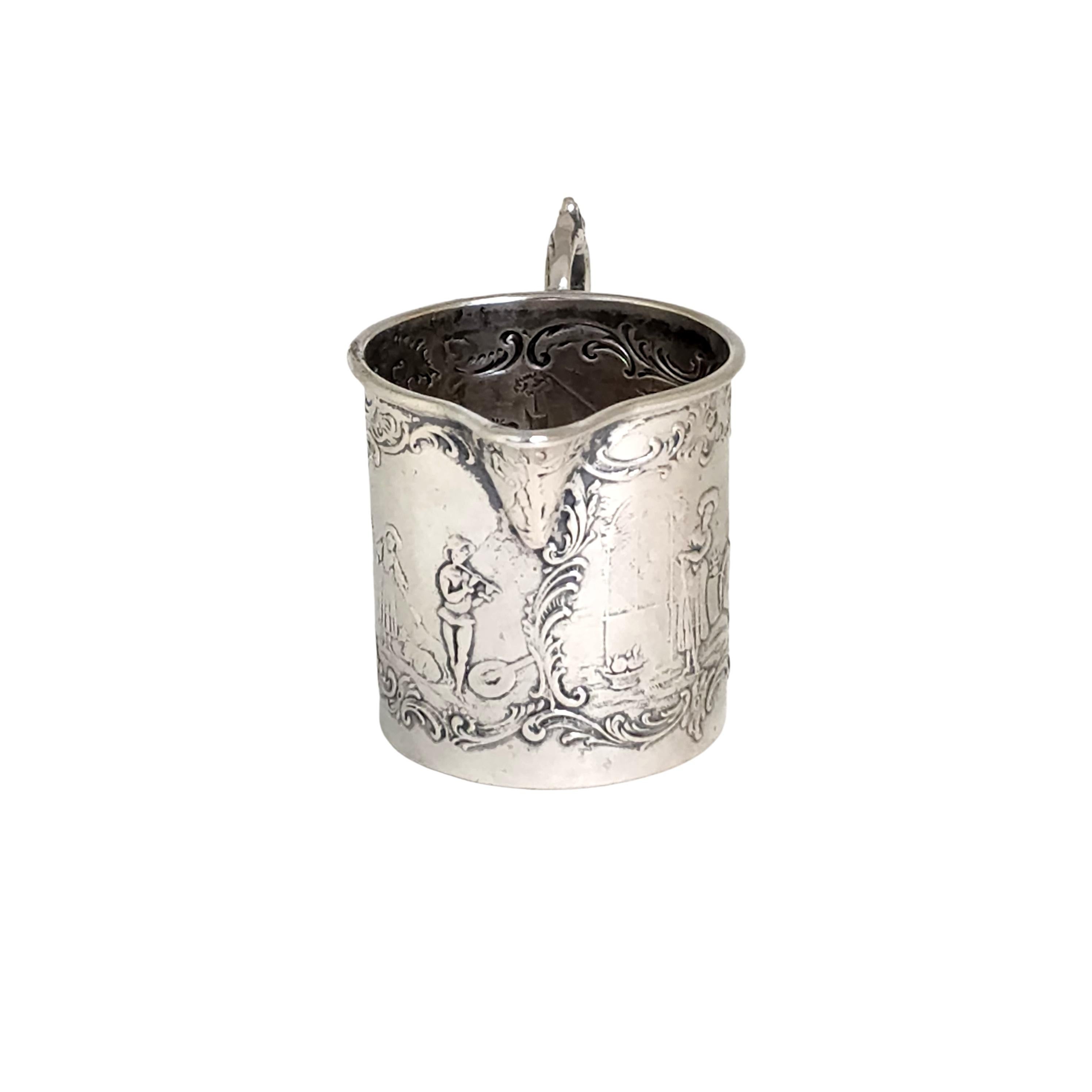800 silver creamer from German silversmith Friedrich Reusswig.

Village scenes surround this creamer from Hanau Germany.

Measures approx 2 1/8
