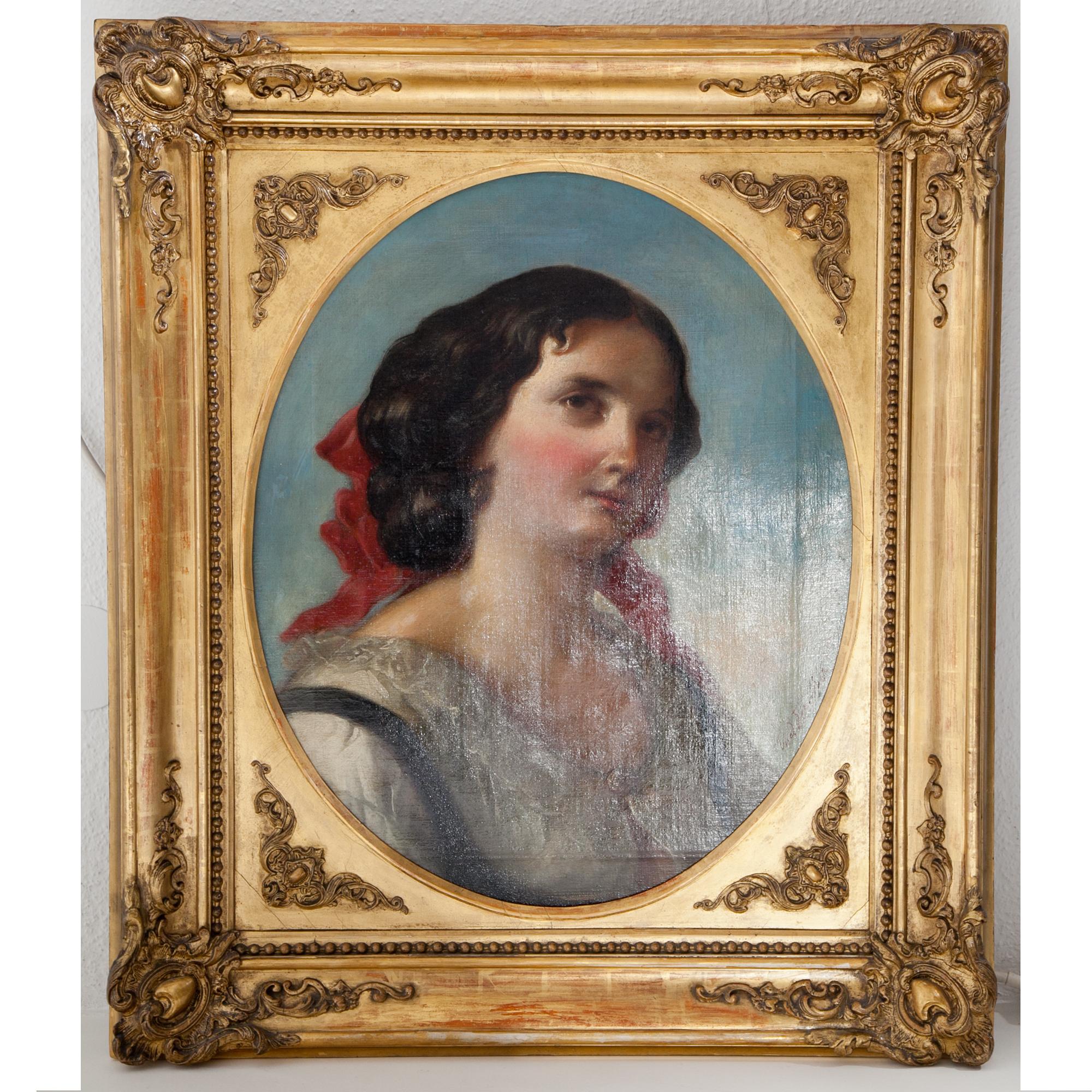 Portrait of a young woman dressed in a white lace blouse, with a red bow in her dark curly hair. She is placed in front of a diffuse blue background in three quarters view. Oil on canvas and framed in a golden patinated frame with an oval cut-out.