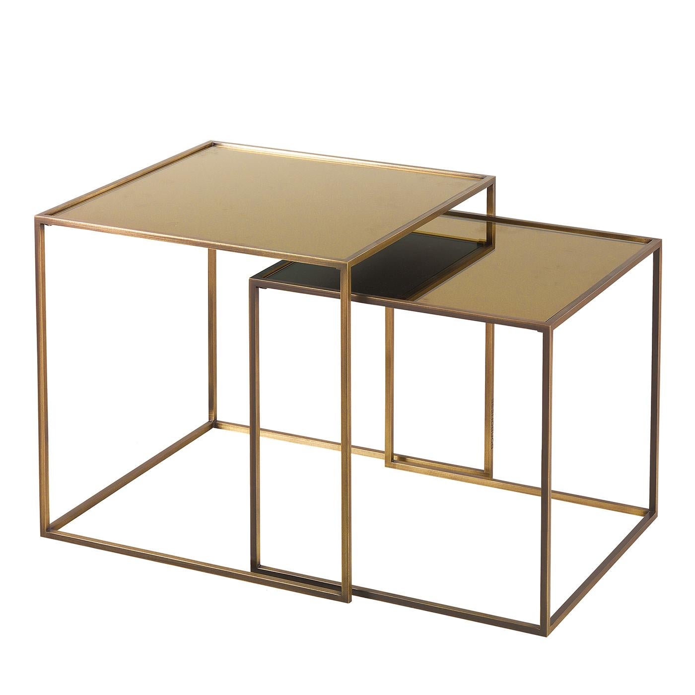 This charming side table is a versatile and elegant addition to a contemporary living room. Entirely crafted of brass, the piece has a minimalist structure open on one side to allow the nesting with the other piece from the Friends collection. The