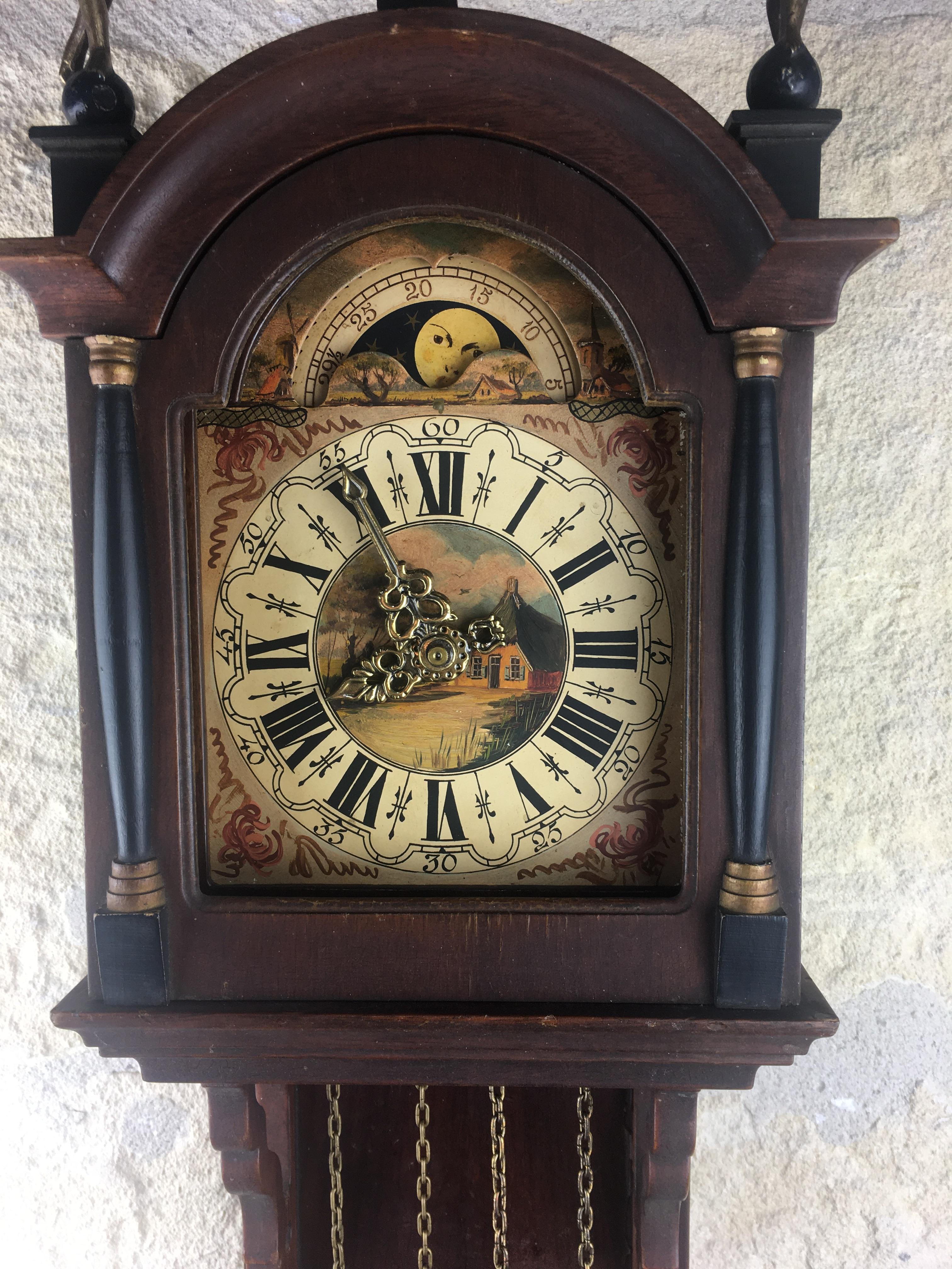 An original vintage Dutch Friesian Schippertje clock. This type of clock was called Schippertje (means Skipper), because it was used on Dutch boats. This is because they were able to keep running as the boat was rocking on the sea. Later on, the