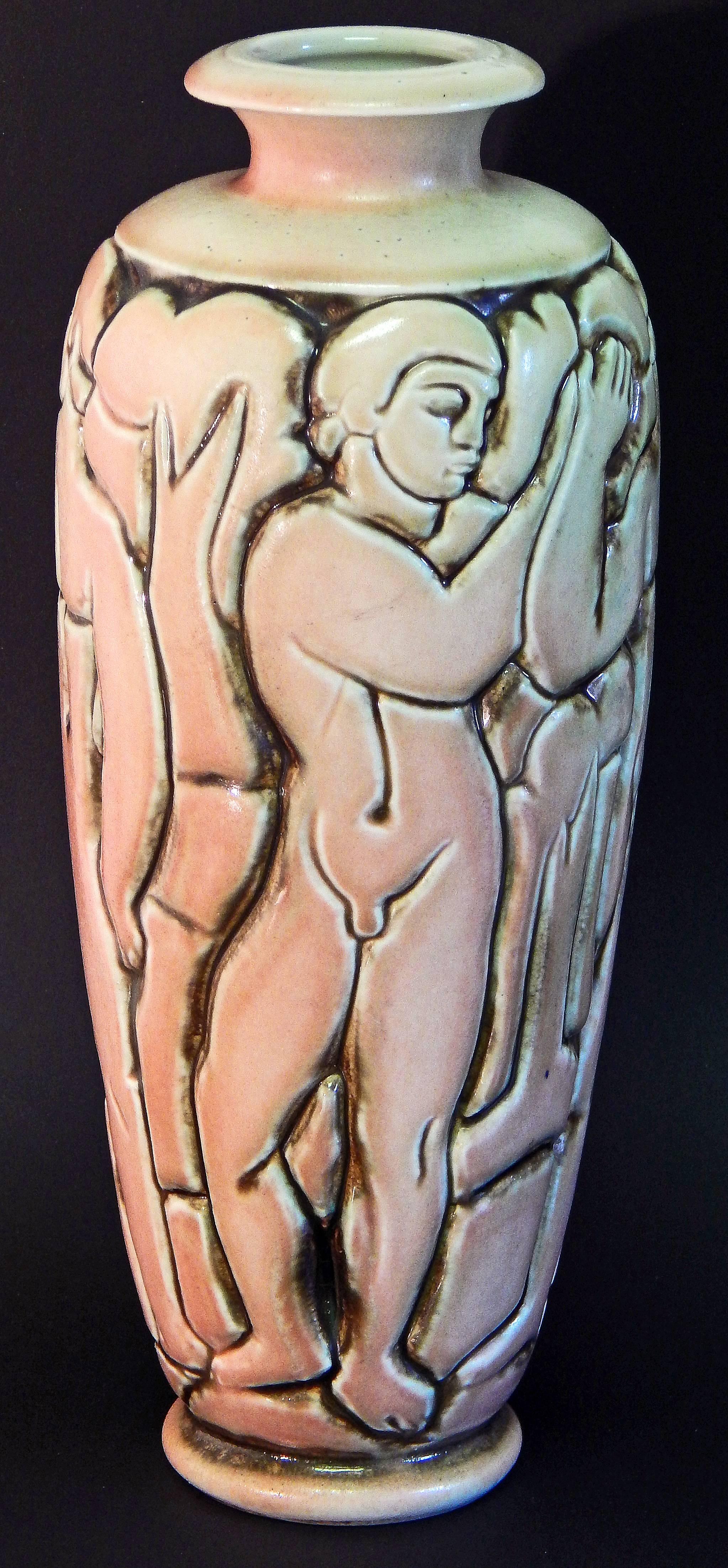 One of the most striking -- and rare -- vases ever produced by the Mougin ceramics firm in France, this vase ringed by four nude male figures clasping hands was sculpted by Gaston Goor. The artist was famous for illustrating a number of books by