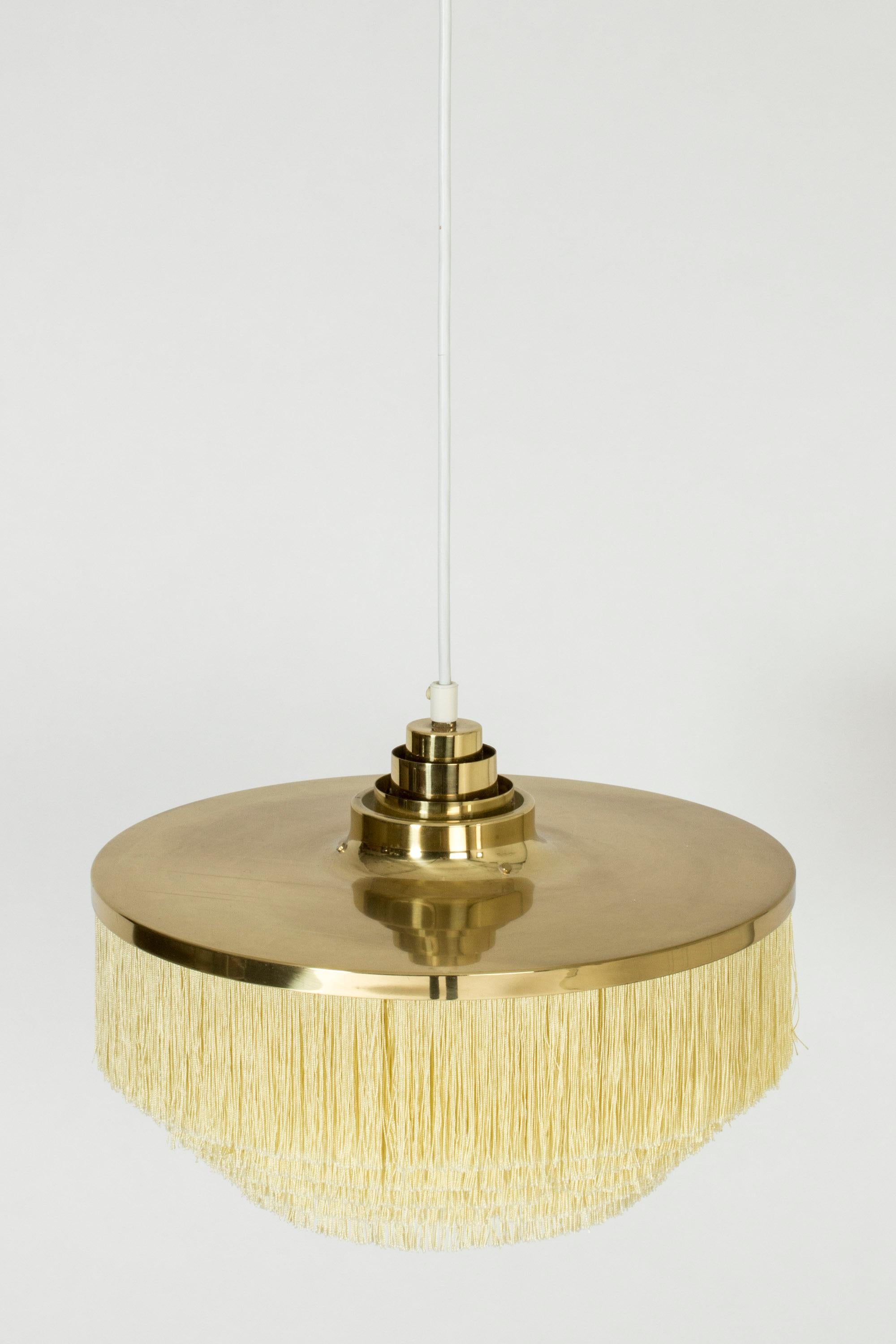 Cool “Fringe” ceiling lamp by Hans-Agne Jakobsson, made from brass. Drapes of textile chords are suspended in layers from shade. Perfect boudoir lighting.