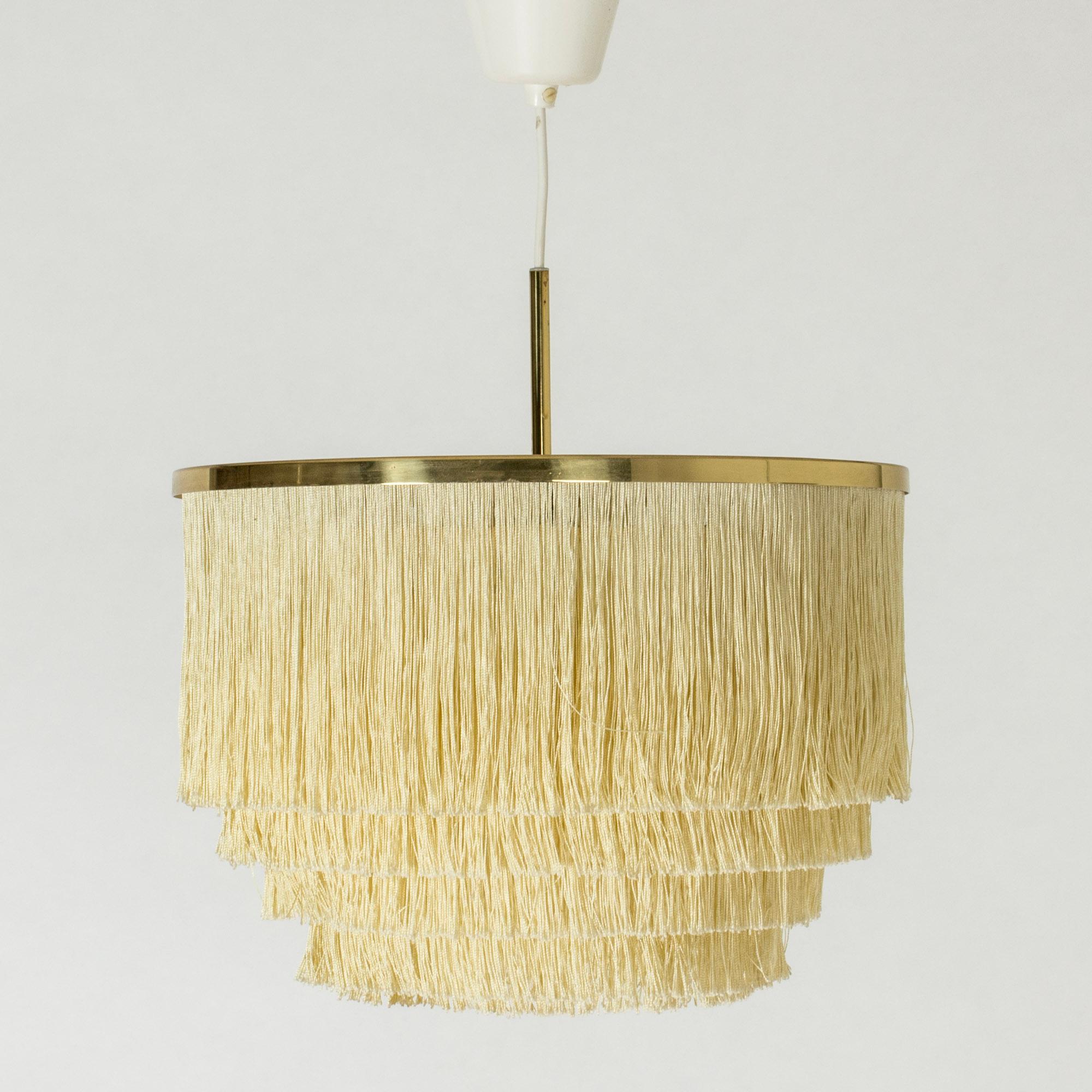 Cool “Fringe” ceiling lamp by Hans-Agne Jakobsson, made from brass. Drapes of textile chords are suspended in layers from shade. Perfect boudoir lighting.