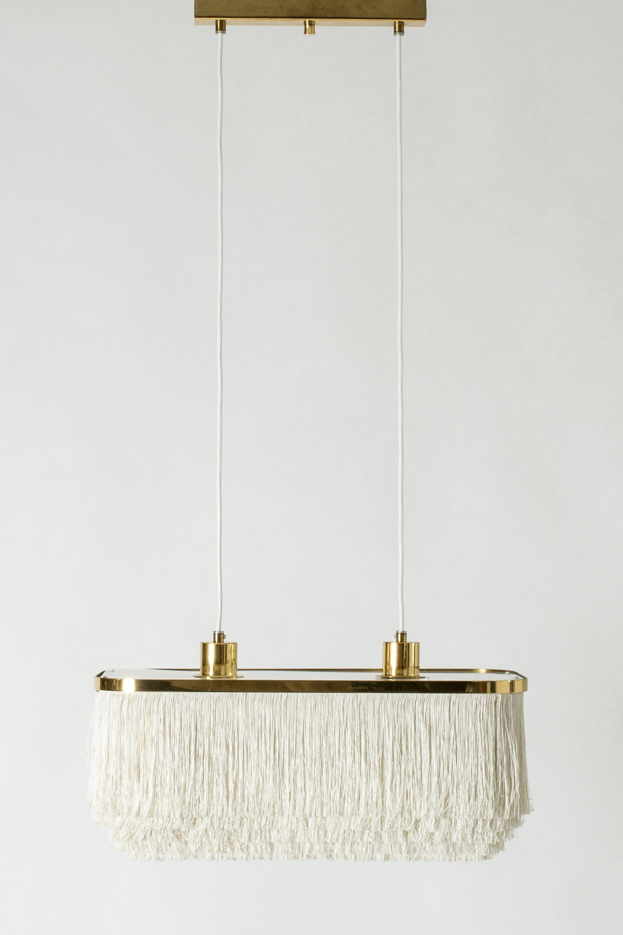 “Fringe” ceiling lamp by Hans-Agne Jakobsson, made with a rectangular brass and plexi glass frame. Drapes of textile chords are suspended in layers from shade. Perfect boudoir lighting.