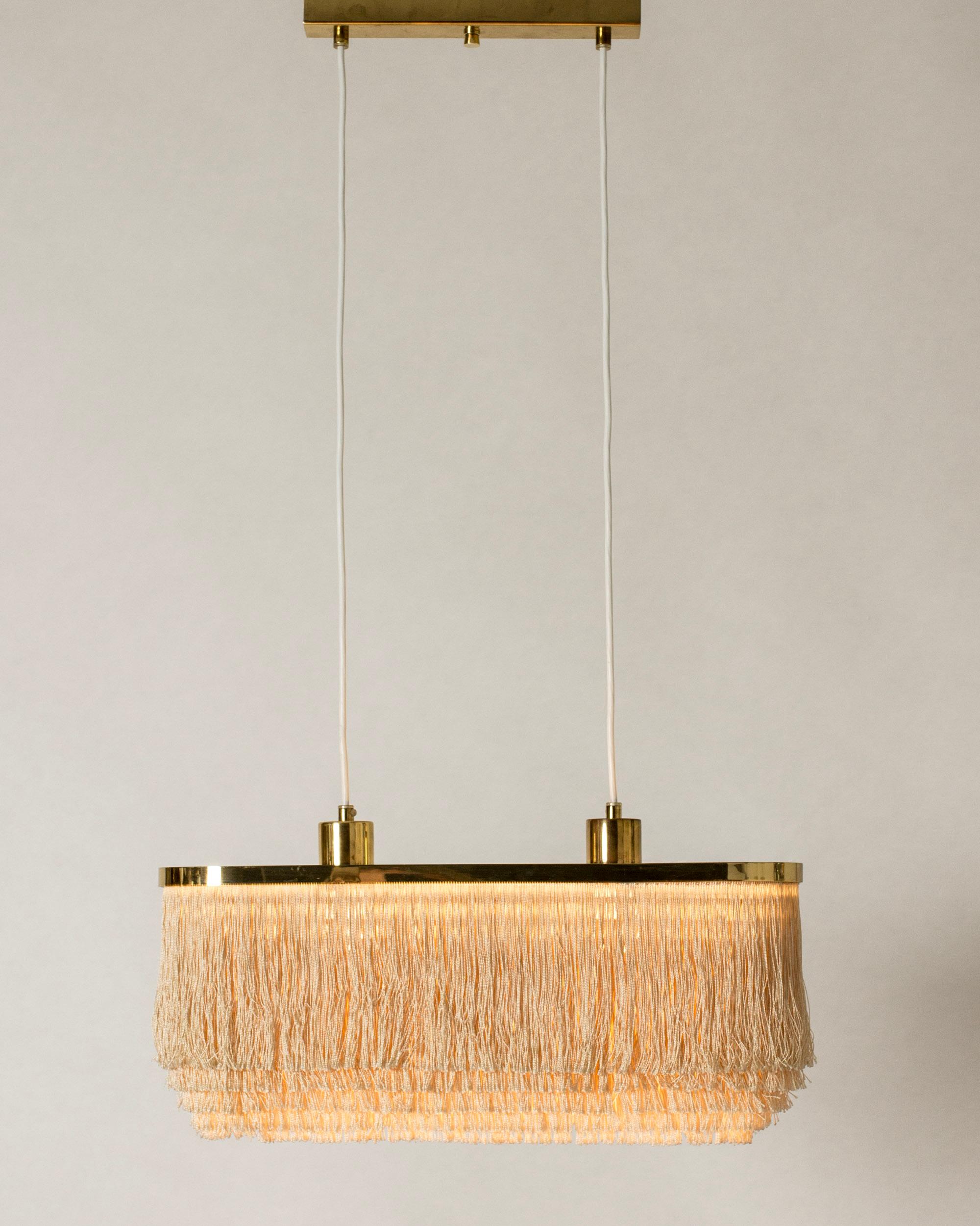 “Fringe” ceiling lamp by Hans-Agne Jakobsson, made with a rectangular brass and plexi glass frame. Drapes of textile chords are suspended in layers from shade. Perfect boudoir lighting.