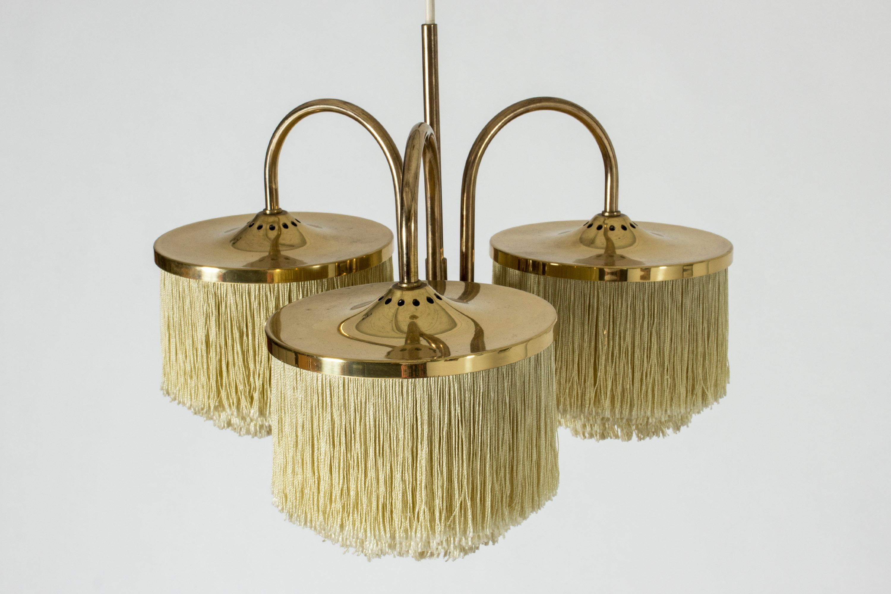 Lovely “Fringe” ceiling lamp by Hans-Agne Jakobsson, made from brass. Drapes of textile chords are suspended in layers from the three shades. Perfect boudoir lighting.