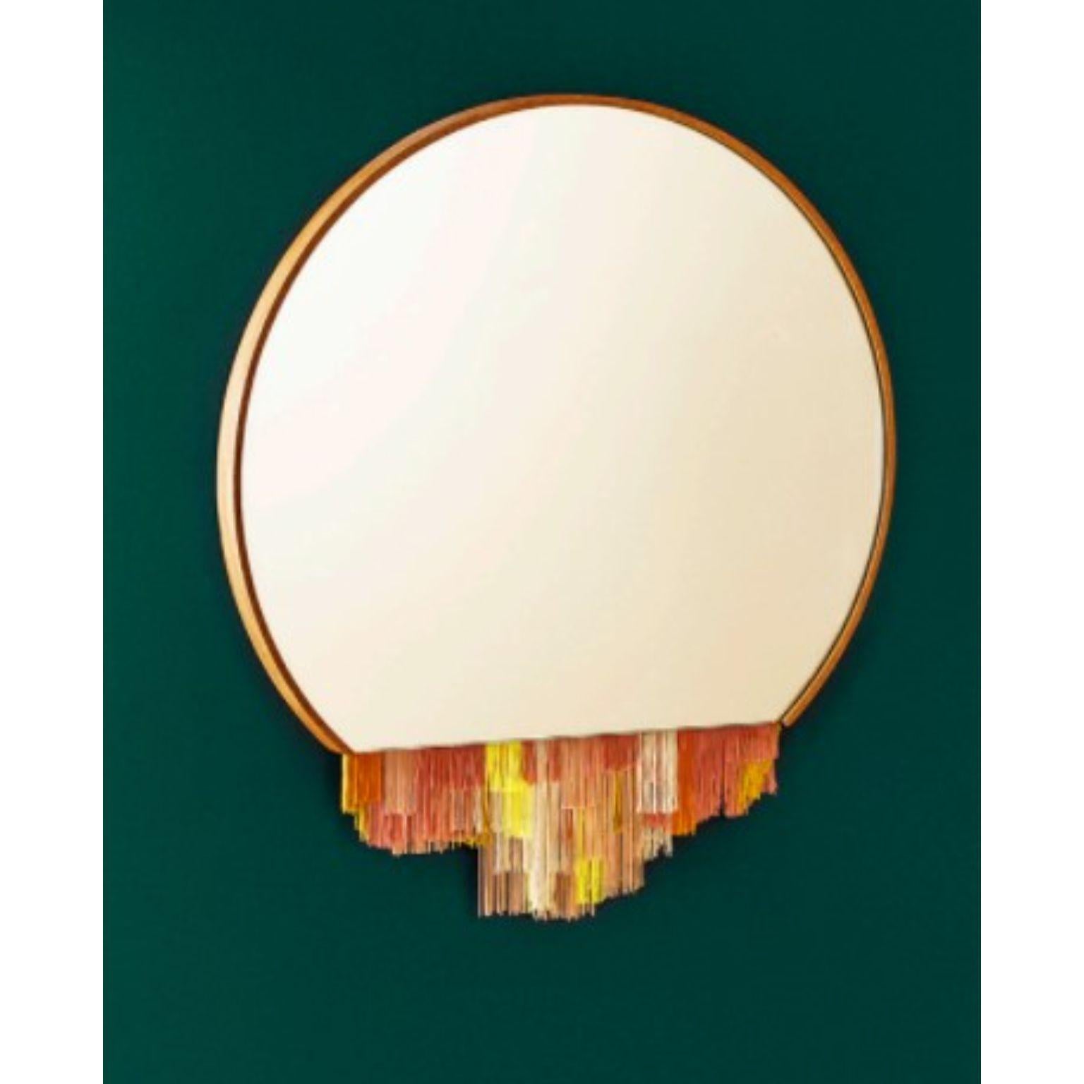 Fringe mirror orange by Tero Kuitunen
Material: oak, glass mirror, textile fringes.
Dimensions: D53 x W53 x H3 cm
Also available : different colors.

Do you remember the old fabric lamp shades with fringe edges? I love how they evoke the urge
