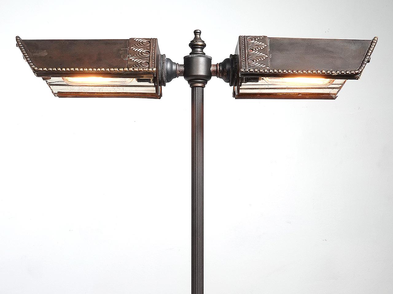 This is a rich looking desk lamp with out being too decorative. It has the simple elegant look of a bankers lamp. Each of the 2 shades have 3 fluted reflector mirrors often found on early 20th-Century lamps manufactured by the Frink Lighting