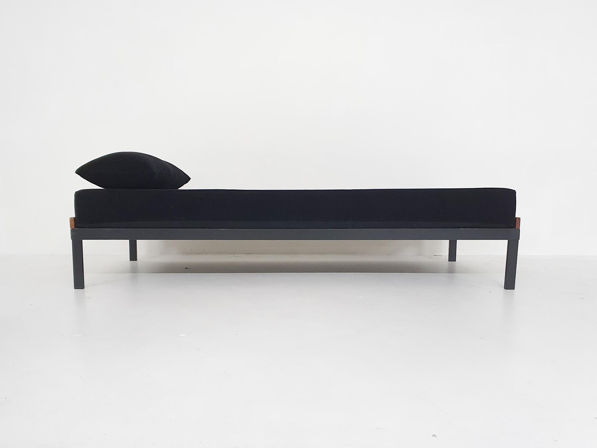 Metal and teak daybed with a mattress and cushion recently upholstered in black rib- fabric.
In good condition.