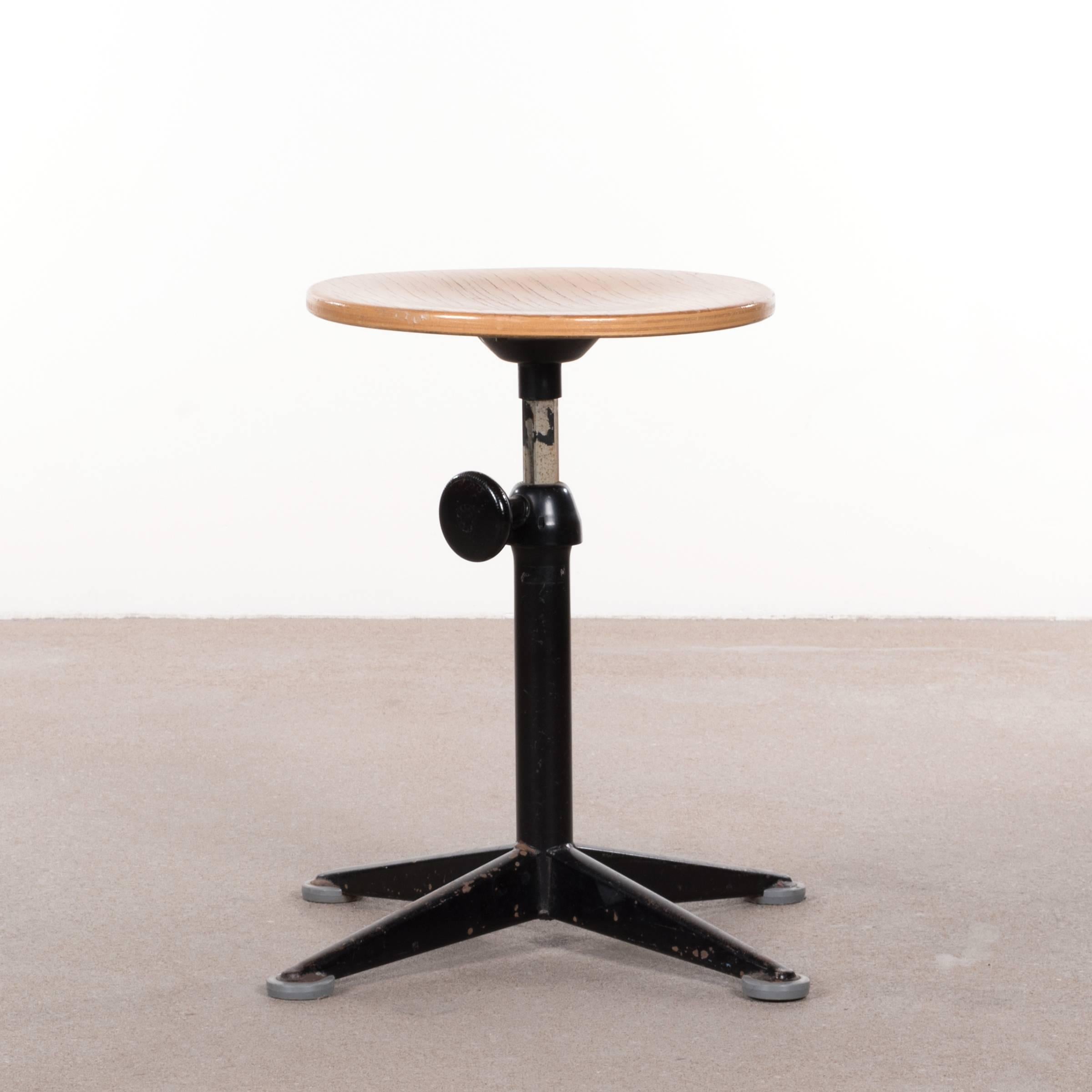 Functional and Industrial stools by Friso Kramer. The stools are adjustable in height (± 45-65 cm) and swivel. Good vintage condition with black enameled steel bases and oak seats. Signed with impressed manufacturer's mark.