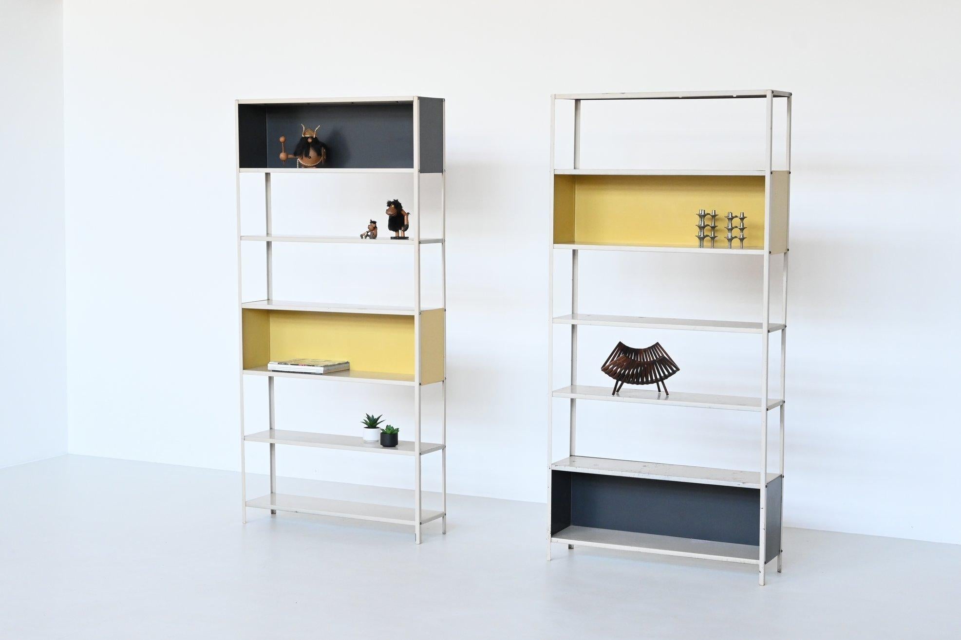 Very nice pair of bookcases or shelving units designed by Friso Kramer for the Bijenkorf and manufactured by Asmeta, The Netherlands 1953. Martin Visser commissioned Friso Kramer to design a simple usable shelving unit for de Bijenkorf. These
