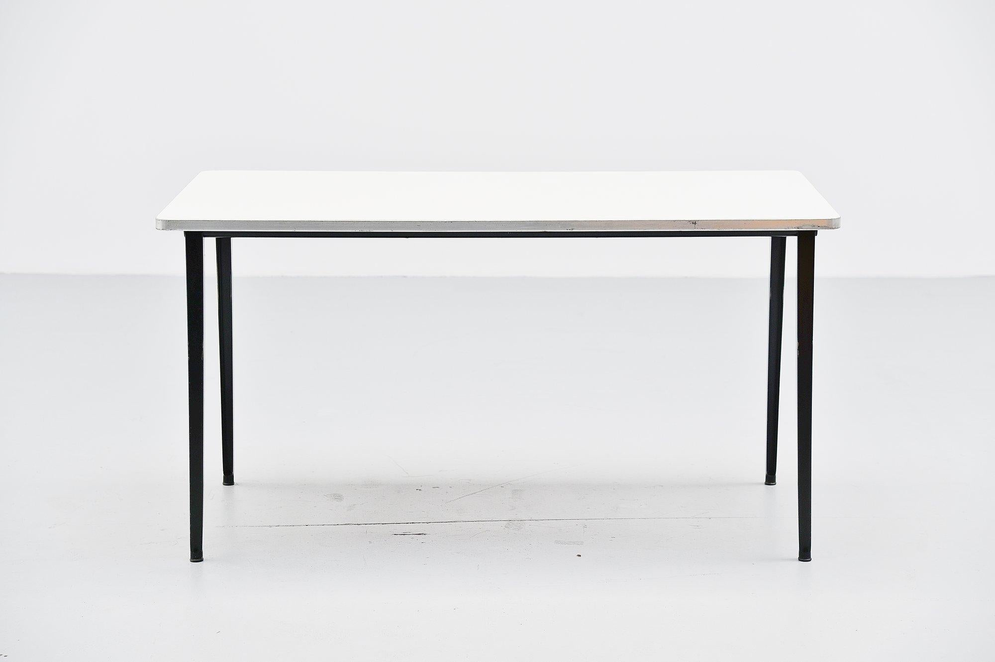 Very nice medium dining or working table designed by Friso Kramer for Ahrend de Cirkel, Holland 1955. This table has a very nice light grey formica top and a black frame, we always have several in stock in a variety of sizes and editions so please