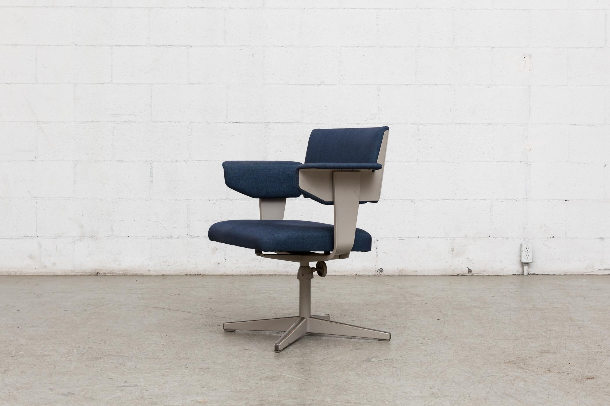 Rare metal framed office chair with adjustable height. Industrial enameled dove grey frame in original condition with visible wear and with some discoloration to enamel. Newly upholstered in indigo blue fabric.