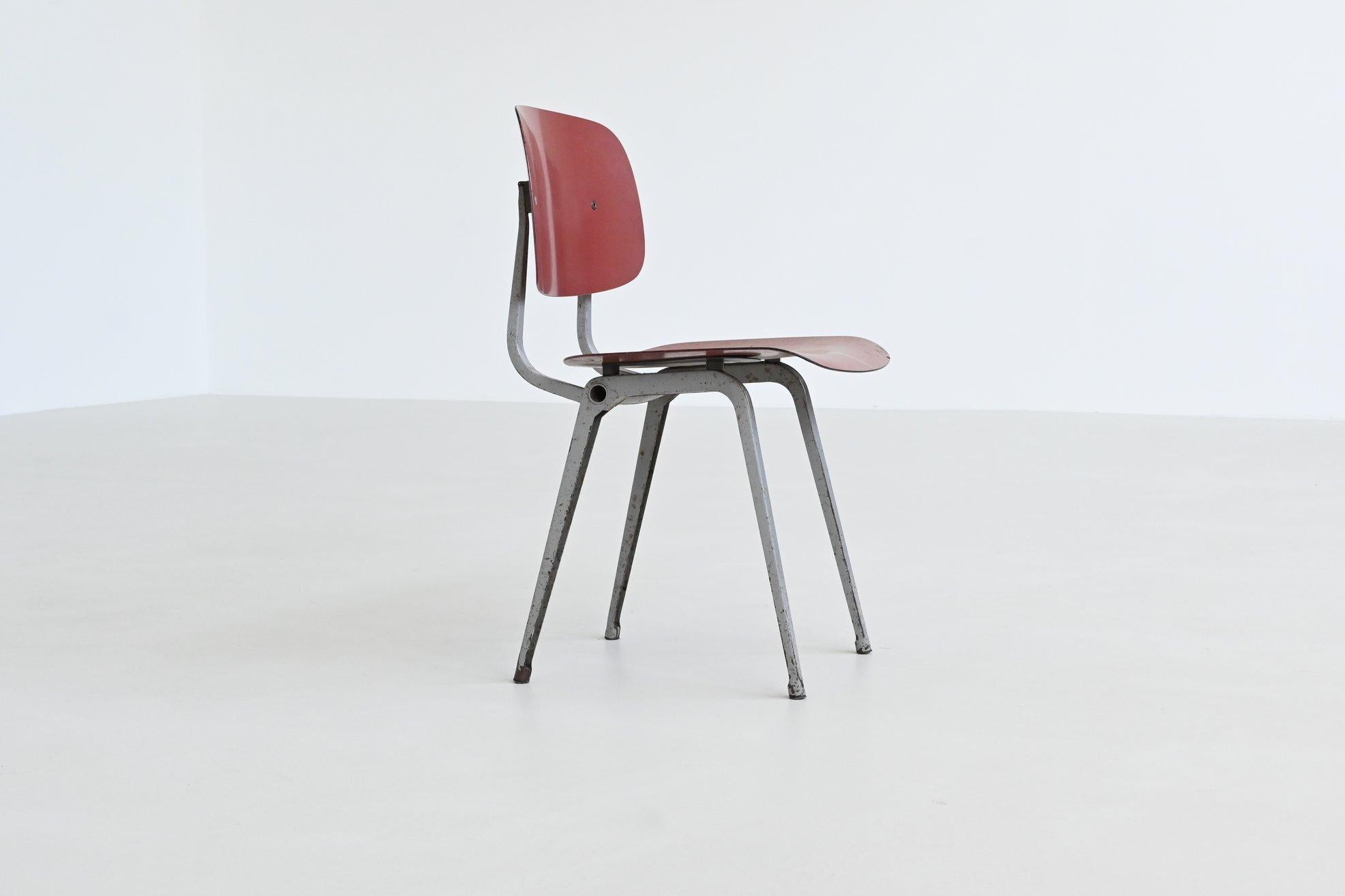 Very nice “Revolt” chair designed by Friso Kramer for Ahrend de Cirkel, The Netherlands 1953. This chair has an original folded light grey lacquered metal frame and a red ciranol seat and back. It features a transparent construction of clear lines