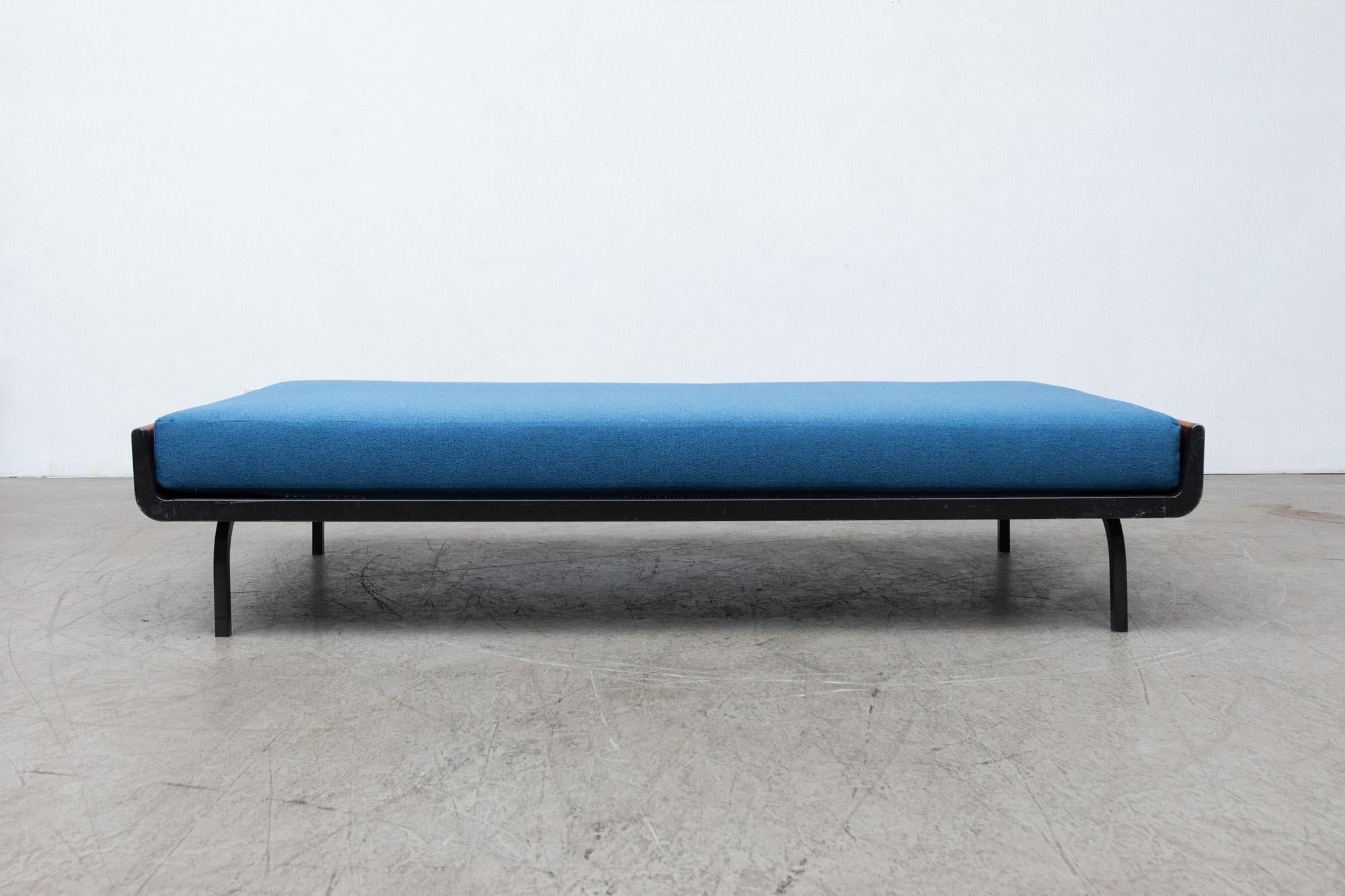 Mid-century daybed with upturned teak ends and dark grey enameled metal frame for Auping. New upholstered azure blue mattress on wire mesh support with original manufacturer stamp. Frames may vary from the one pictured, but all with similar wear. In