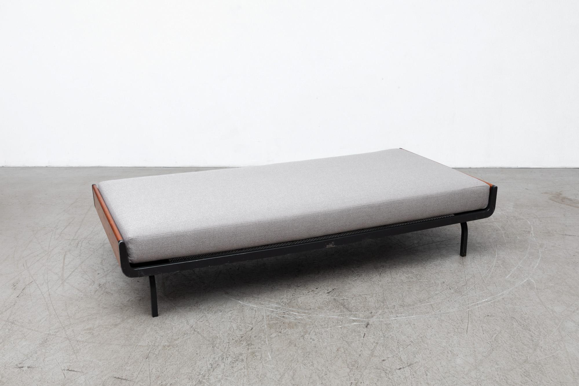 Mid-century daybed with lightly refinished upturned teak ends and dark grey enameled metal frame for Auping. Freshly upholstered grey mattress on wire mesh support with original manufacturer stamp. Frames may vary. In original condition with some