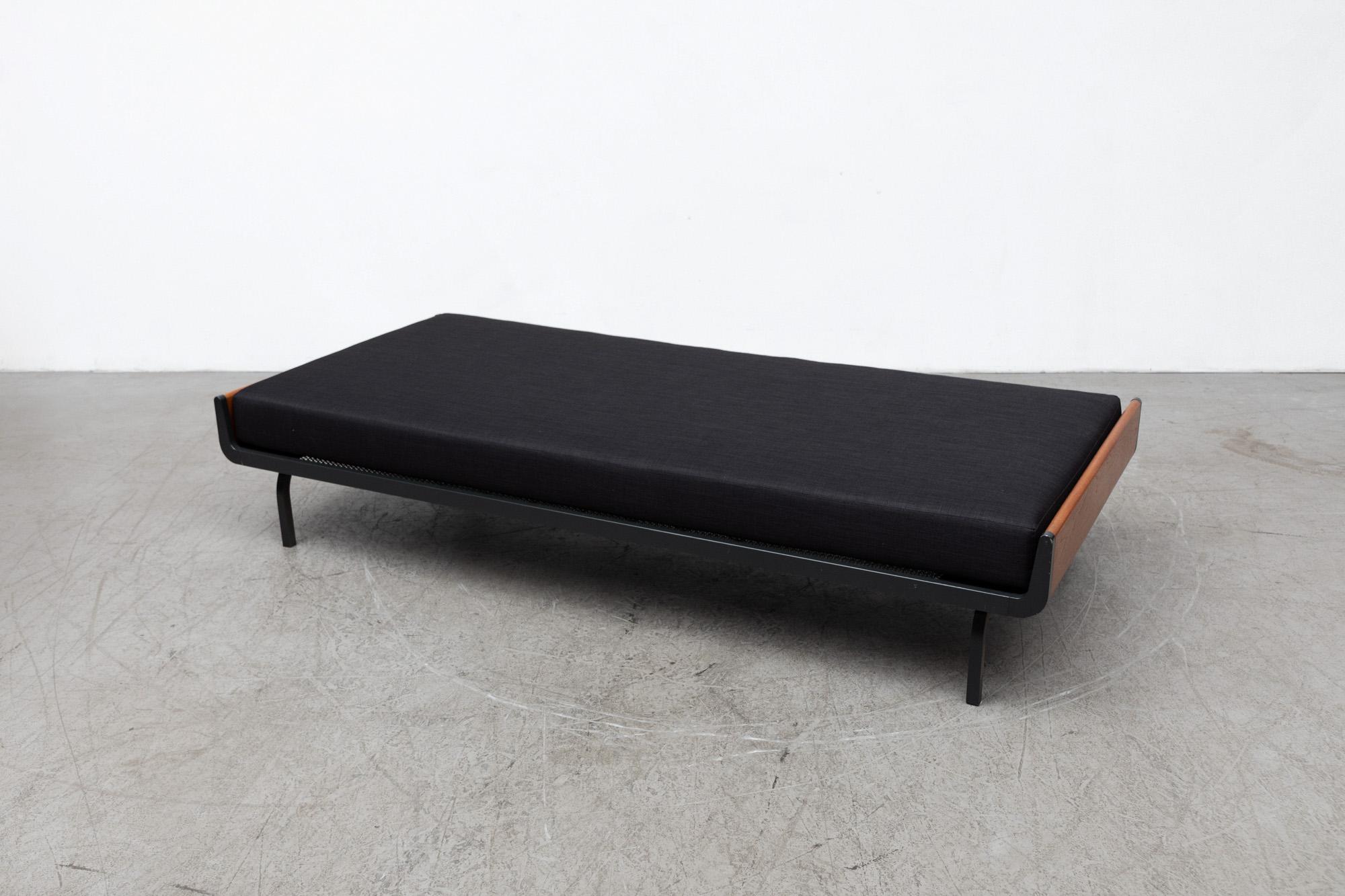 Mid-century extra long daybed with upturned teak ends and dark grey enameled metal frame with wire mesh support for auping. New upholstered black mattress. Frames may vary from the one pictured, but all have similar wear. In original condition with