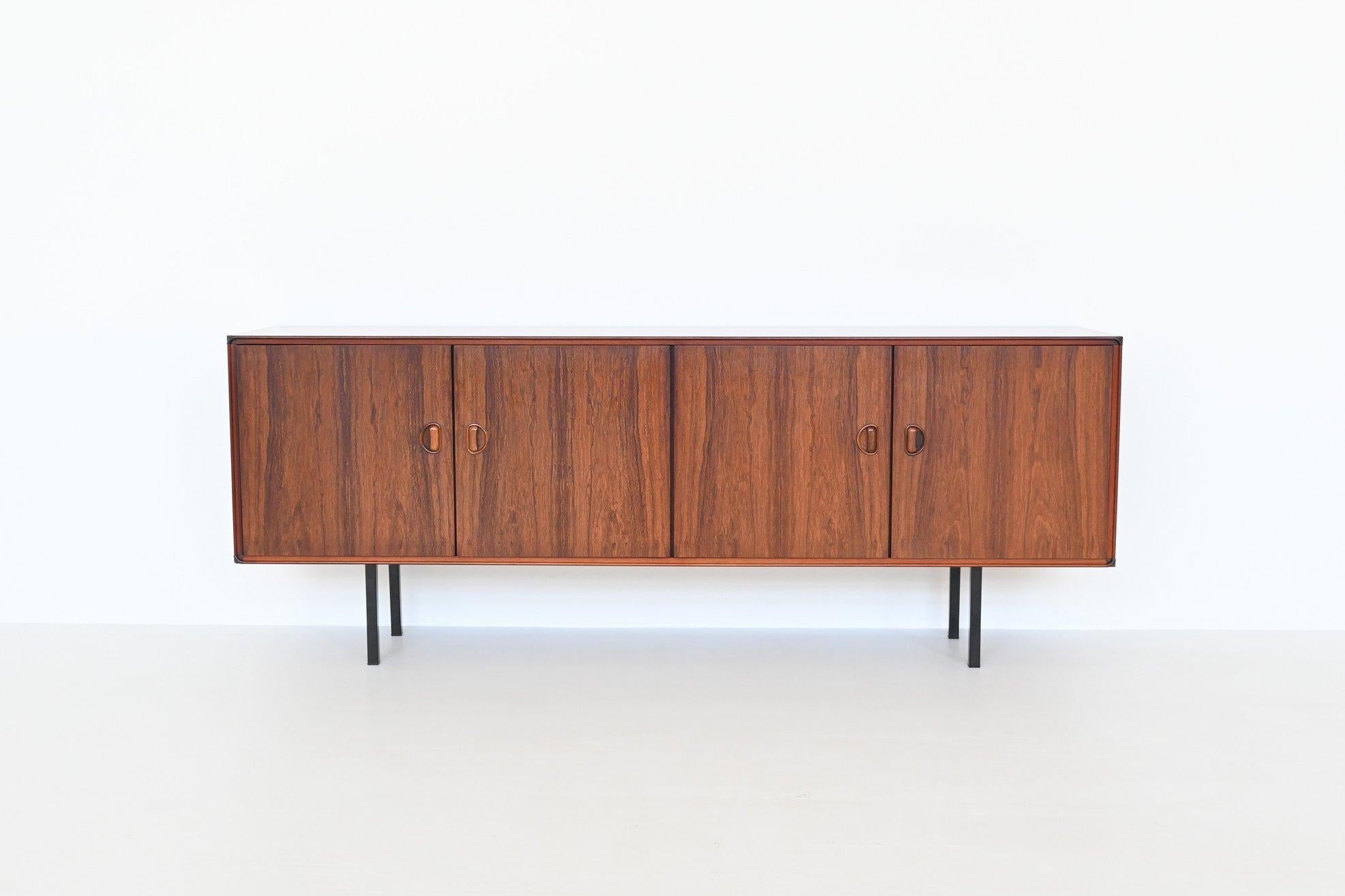 Beautiful refined quality symmetric sideboard manufactured by Fristho Franeker, The Netherlands 1960. This sideboard is made of nicely grained rosewood veneer supported by four metal feet. It has four doors with two large shelves behind. Nicely