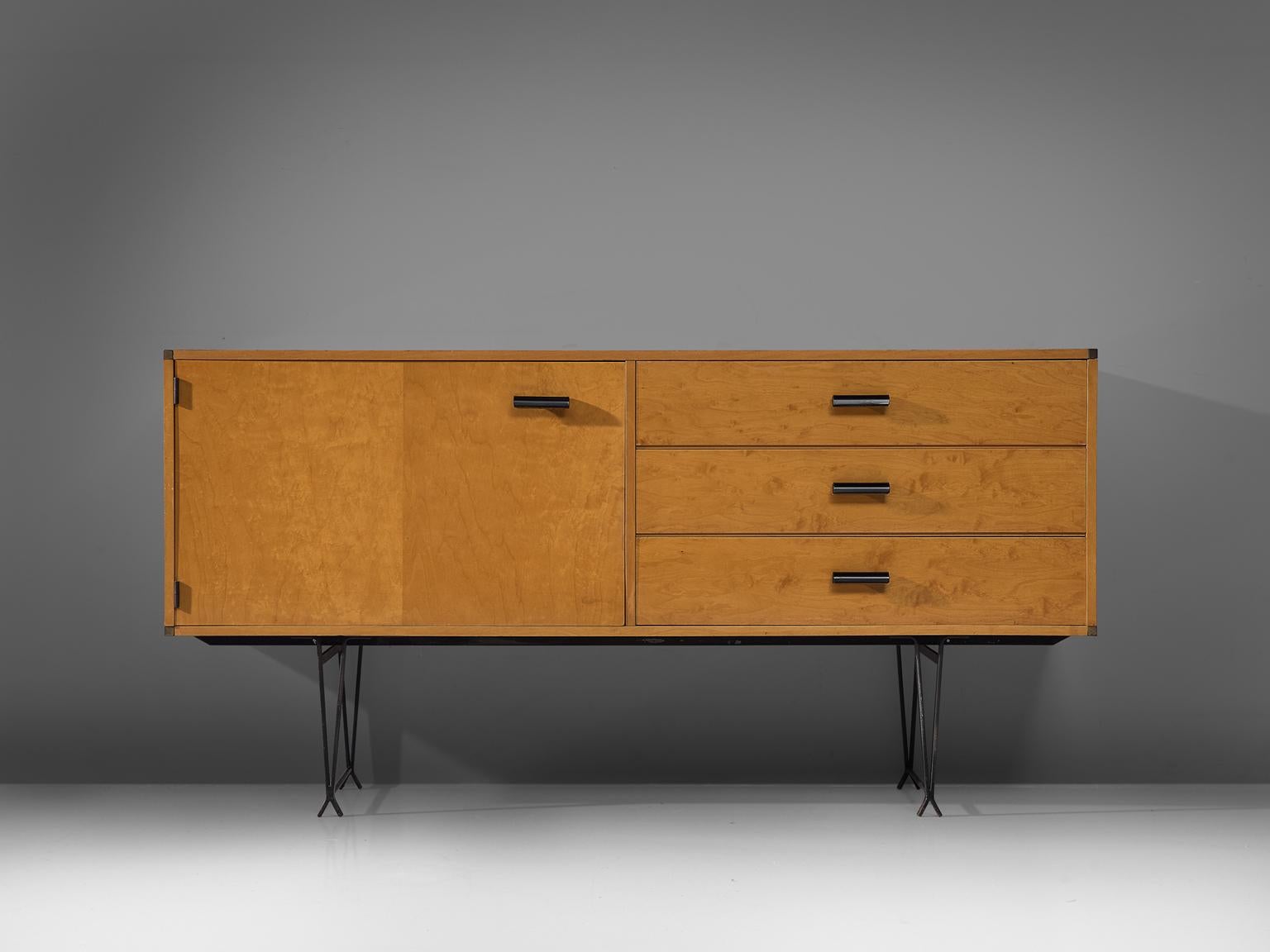 Fristho, wood, metal, brass, the Netherlands, circa 1950.

Elegant sideboard in wood with brass details. This cabinet shows very refined metal legs, which create a floating character. The black coated solid legs are in wonderful contrast with the