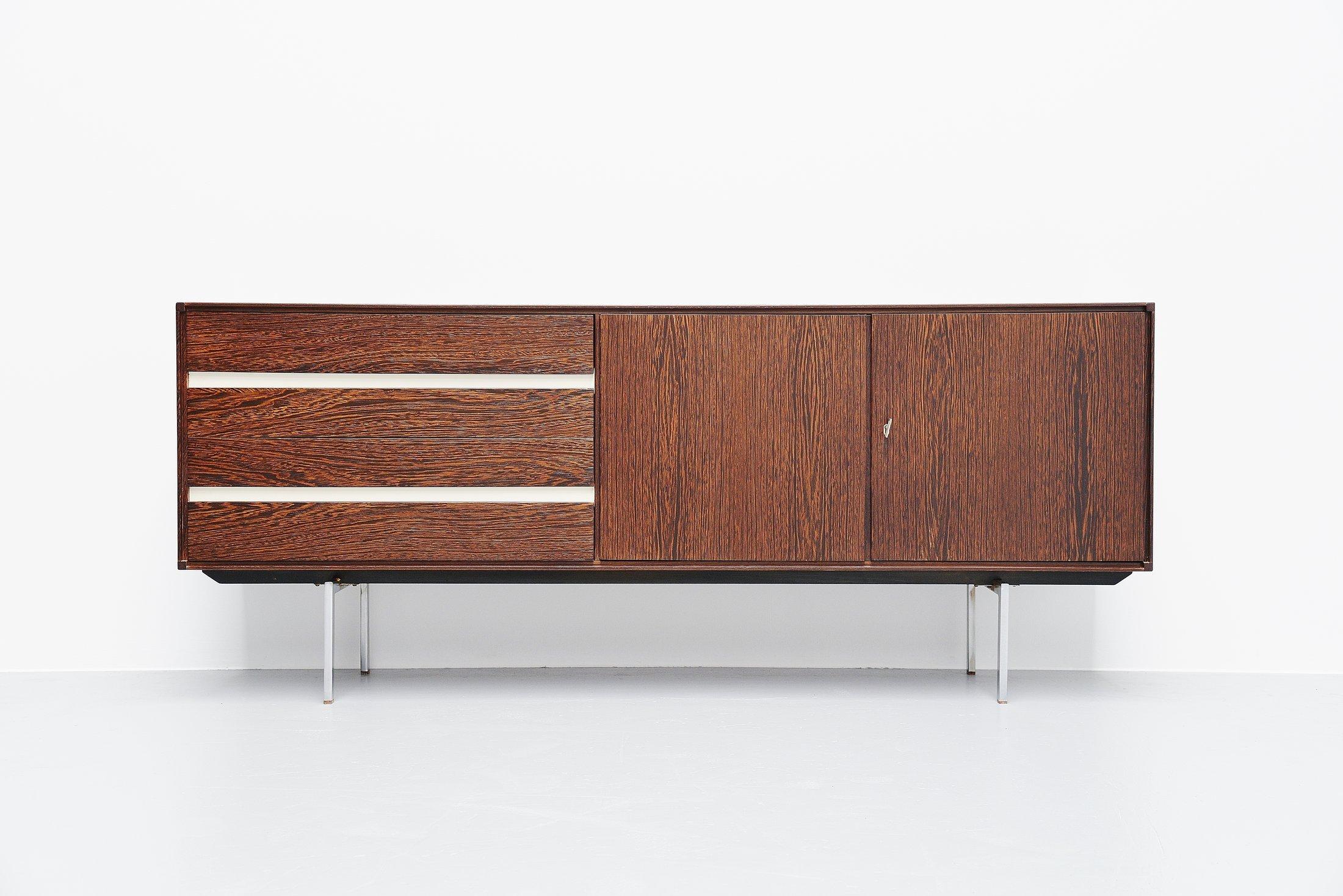 Very nice small modernist sideboard designed by Rudolf Bernd Glatzel and manufactured by Fristho Franeker, Holland, 1965. This sideboard has a very nice timeless design and the rare protected wood kind Wenge with amazing grained wood makes this a