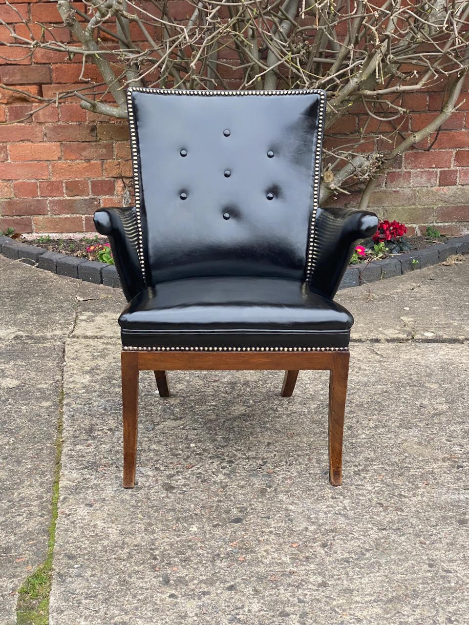 Frits Henningsen armchair Denmark Circa 1932

Magnificent mid century Frits Henningsen Leather & Mahogany Armchair Denmark circa 1932, the buttoned back chair with two gull like arm supports is finished in the finest black leather with brass stud