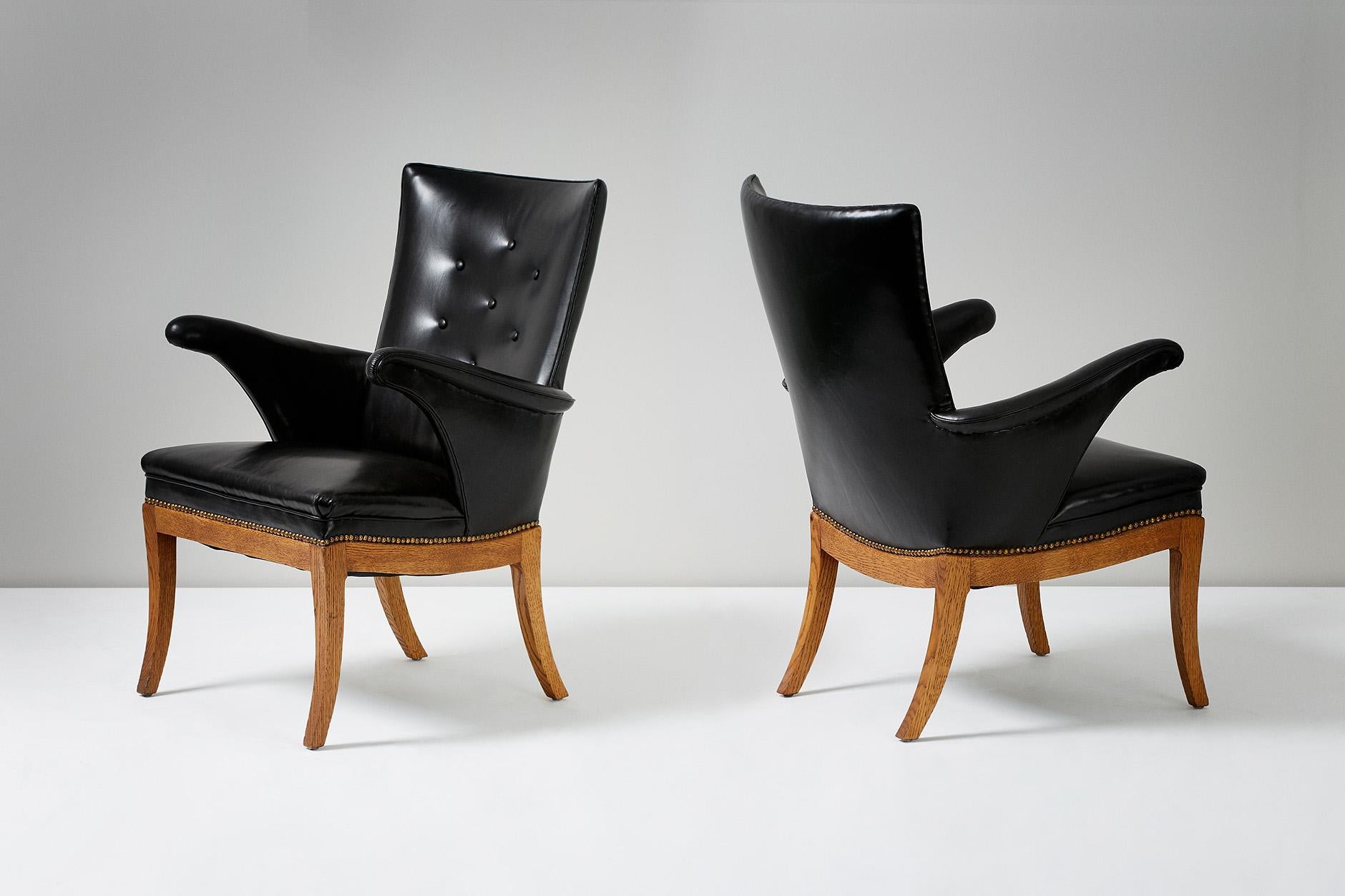 Frits Henningsen (1889 - 1965)

Pair of armchairs, 1932

Designed and produced by master cabinet maker Frits Henningsen in Denmark, circa 1932. Patinated oak base, seats upholstered in black leather and fitted with brass nails. 

Henningsen,