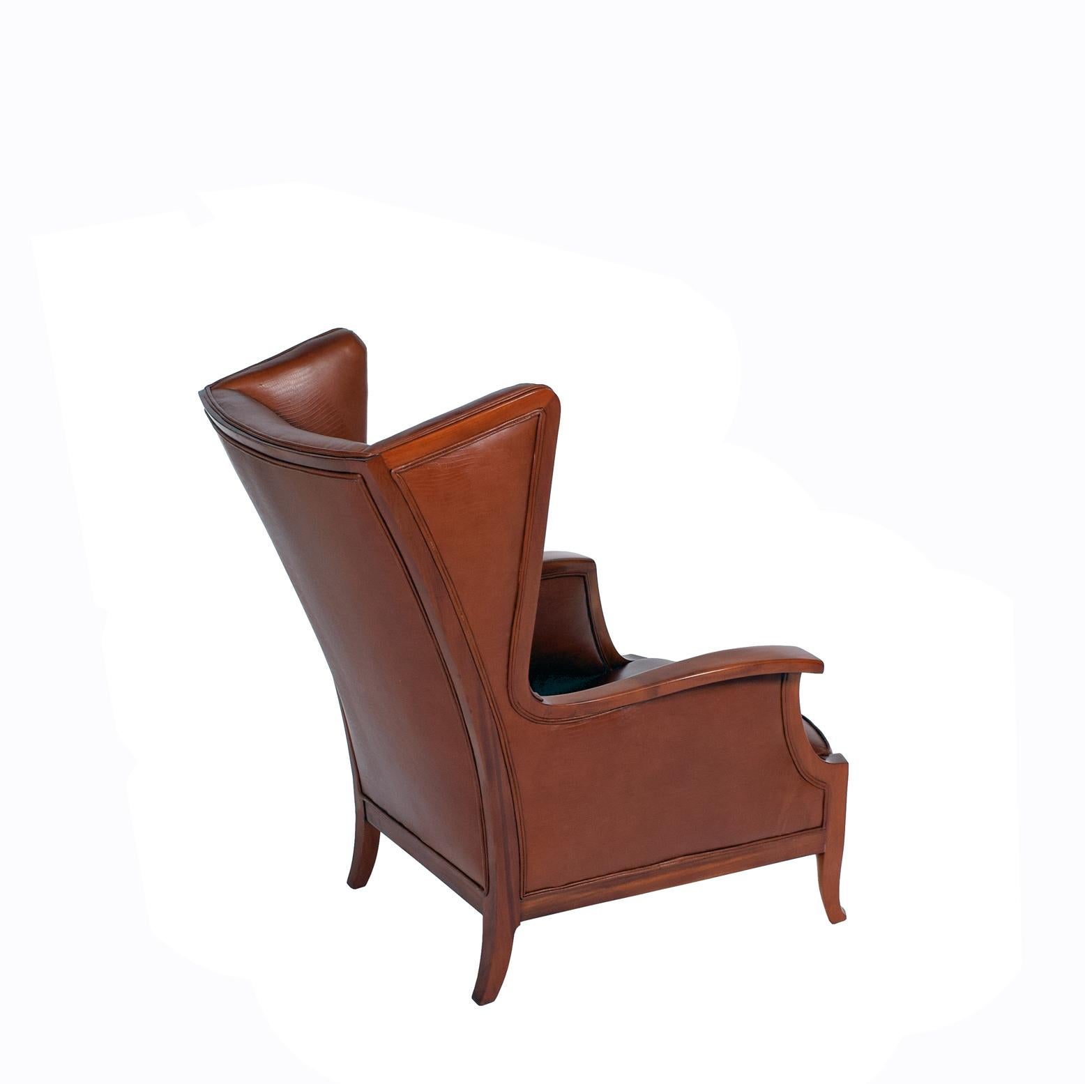 Solid mahogany frame, sides seat and back with reddish patinated Italian leather probably made by Frts Henningsen.
