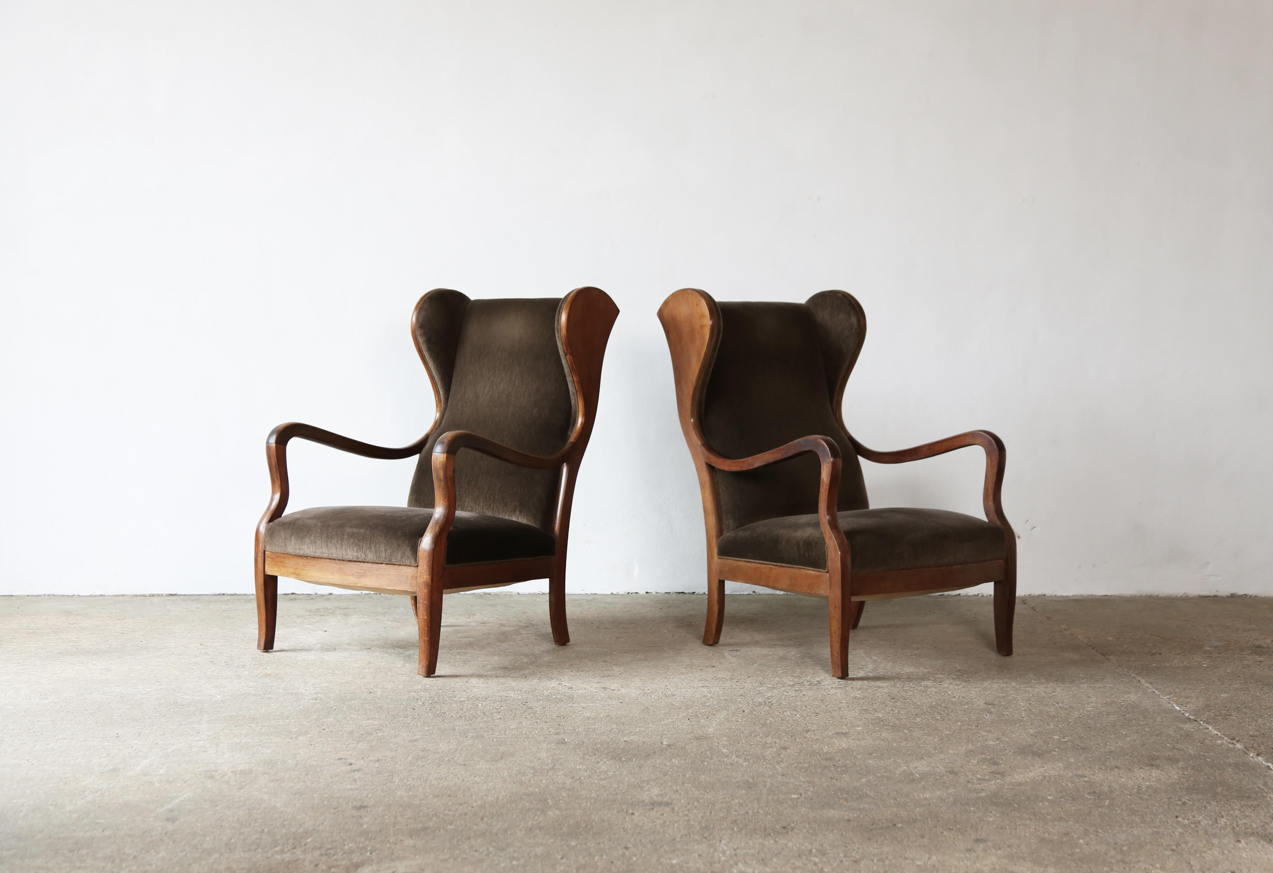 An original pair of Frits Henningsen chairs, Denmark, 1940s. Designed and produced by Frits Henningsen, Copenhagen. The chairs have presumably been reupholstered at some point in their history but is easy to recover in different fabric if desired.