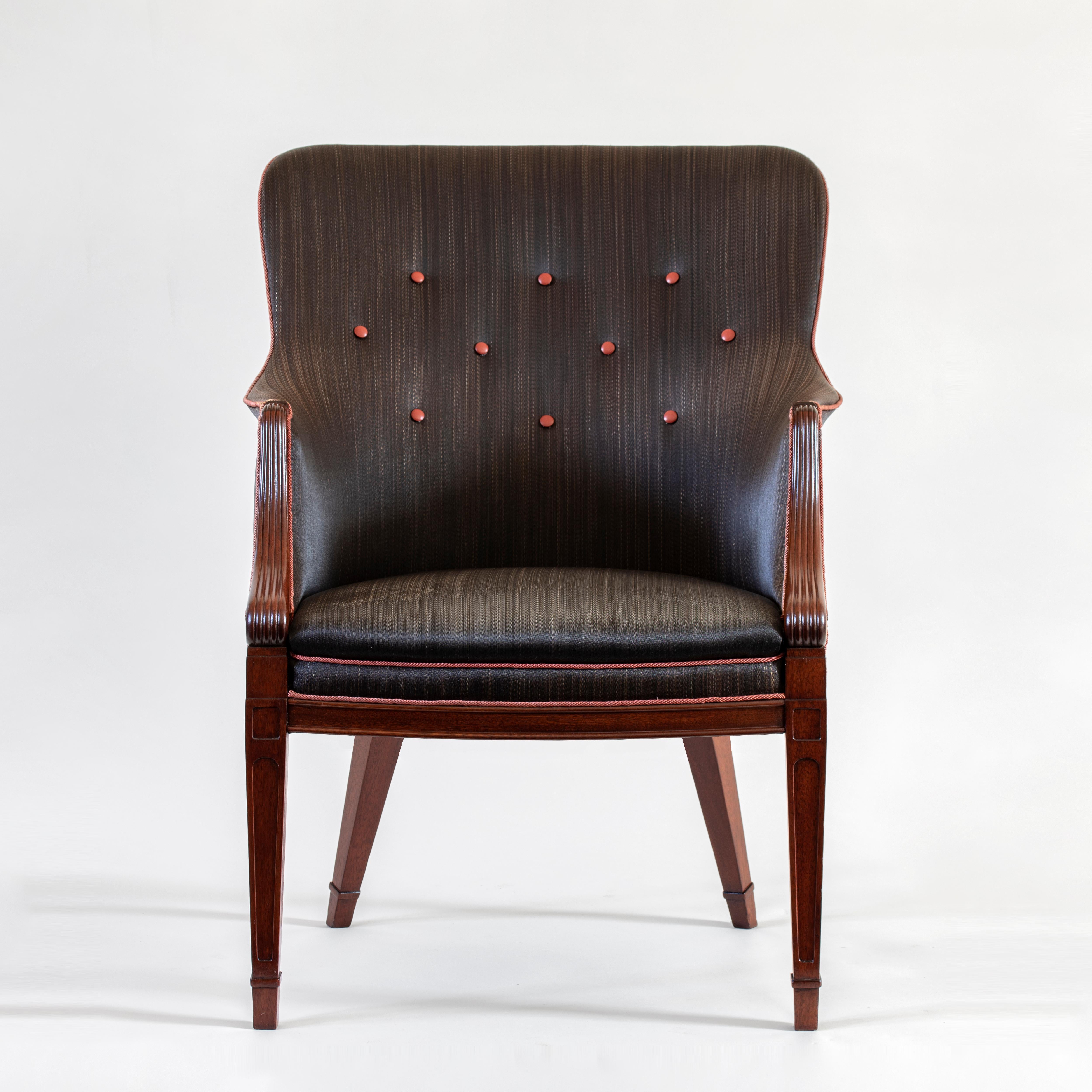 A rare example from master cabinetmaker Frits Henningsen in its original, beautifully preserved horsehair upholstery. Iconic design combined with sumptuous materials; the armchair is large, stylish and very comfortable. 

The concave toprail above