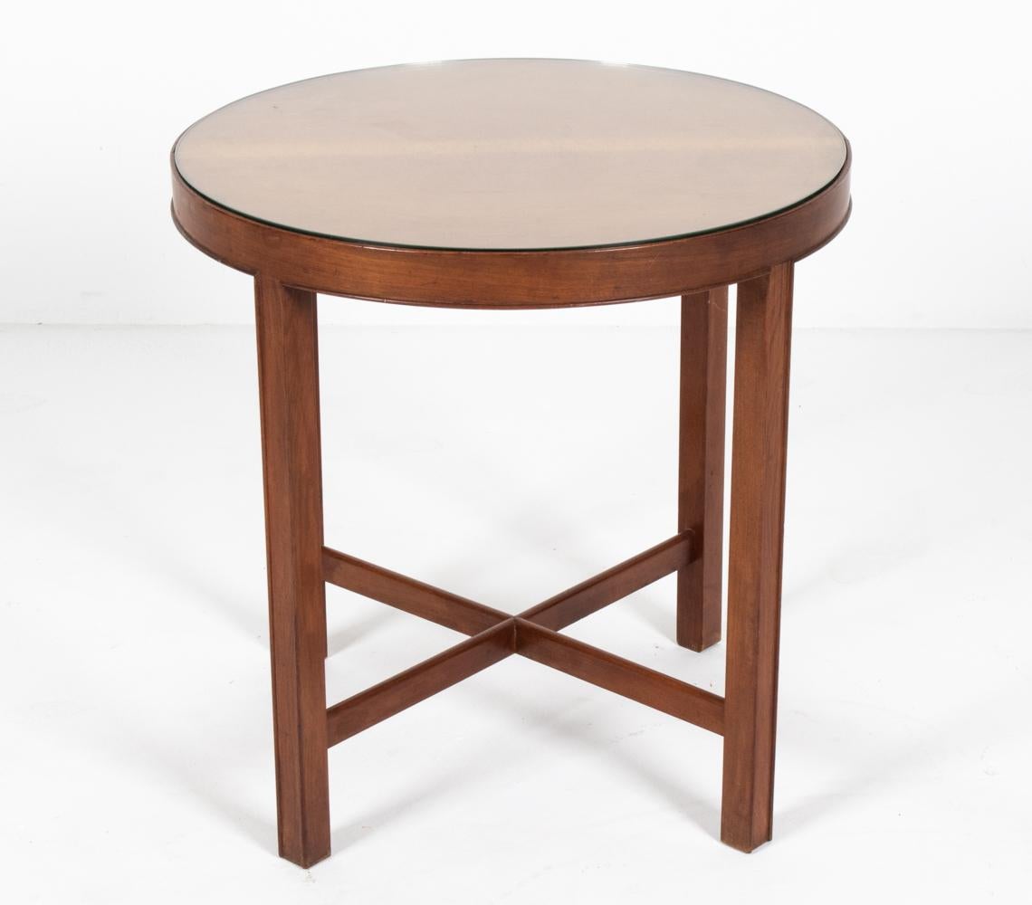 A handsome Danish mid-century round side table, designed by furniture maker and designer Frits Henningsen (1889–1965), c. 1940's. Both the proprietor of a furniture-making workshop with a team of cabinetmakers in central Copenhagen as well as the