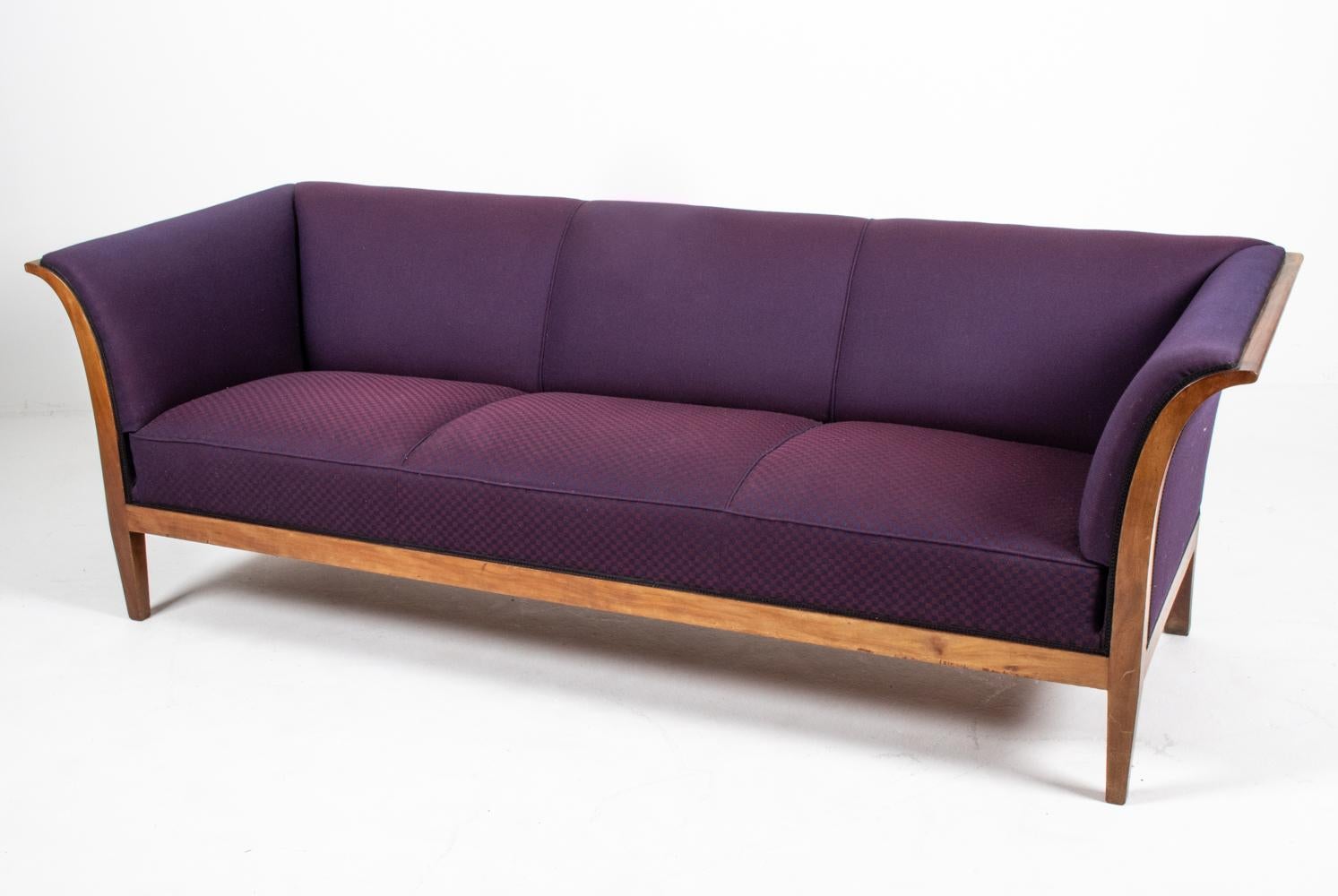 A handsome Danish mid-century three-seater sofa, designed by furniture maker and designer Frits Henningsen (1889–1965), c. 1940's. Both the proprietor of a furniture-making workshop with a team of cabinetmakers in central Copenhagen as well as the