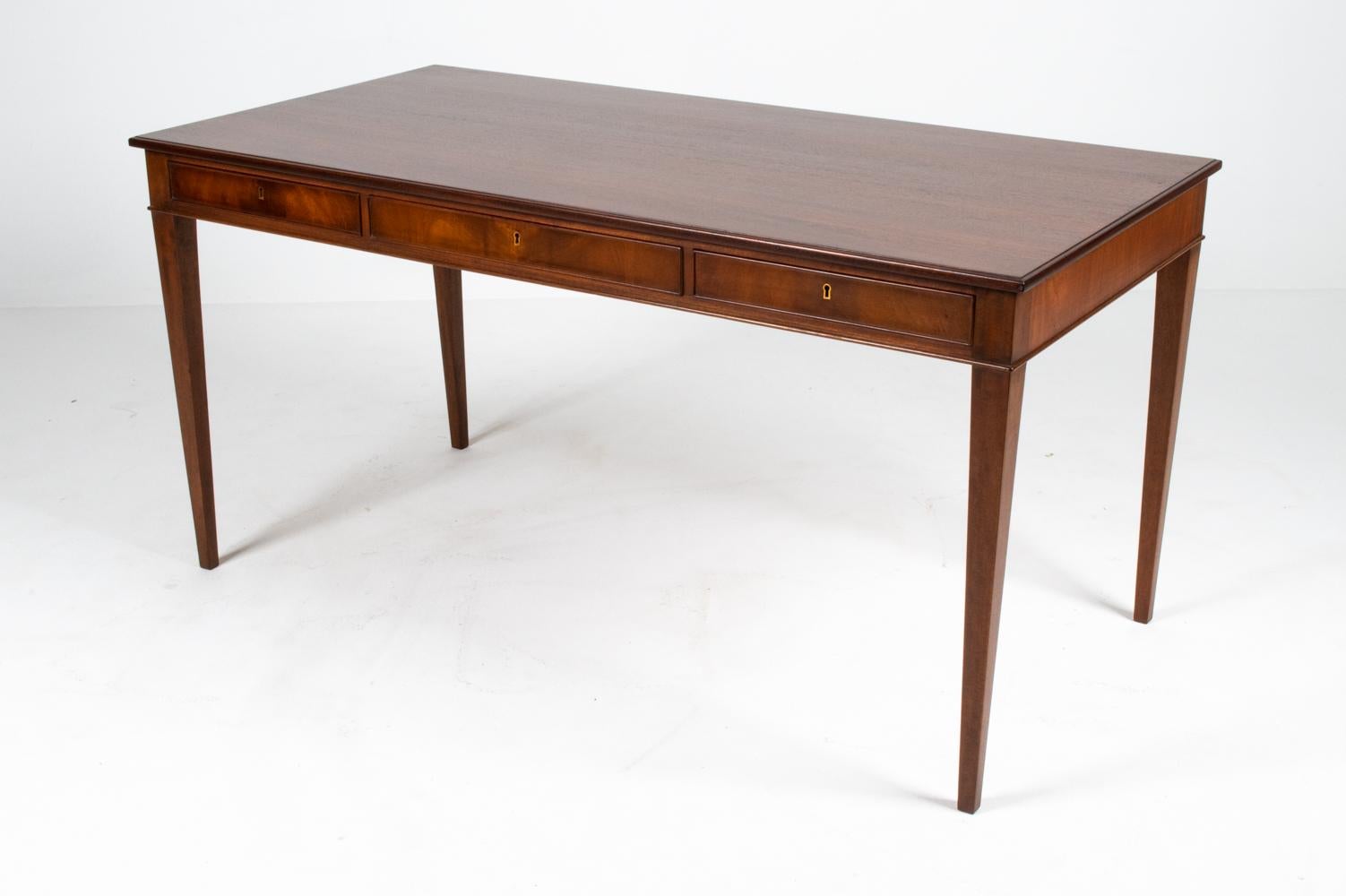 A rare and highly sought after three-drawer model of Frits Henningsen's elegant executive desk. Famous for his perfectionist mentality, early-mid Danish 20th century architect and furniture designer Henningsen insisted that the majority of his