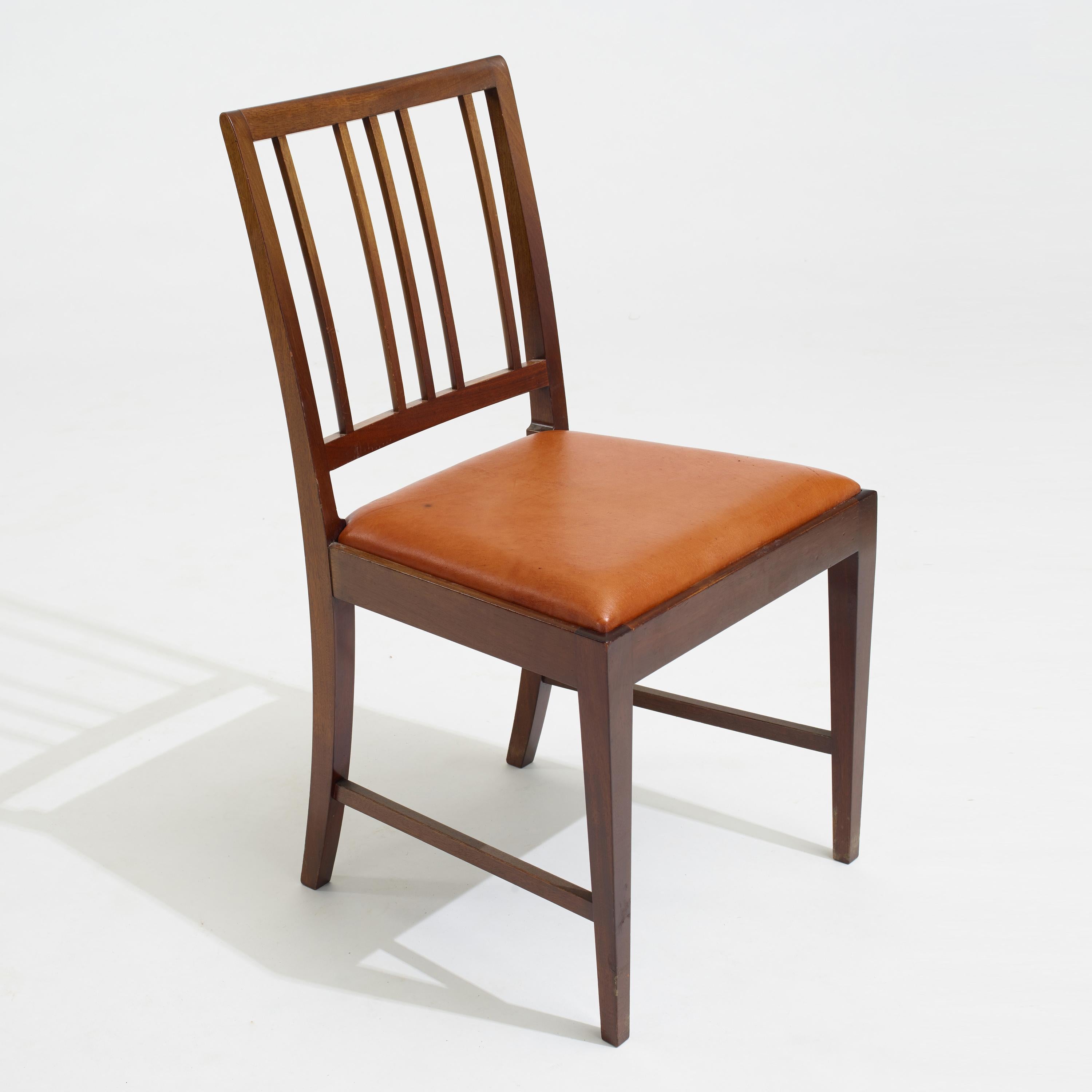 Danish Modern mahogany dining chairs by Frits Henningsen, Denmark, circa 1930s. They have probably been refinished and reupholstered at some point. Beautiful caramel color leather seats. We also have the matching dining table from the same estate