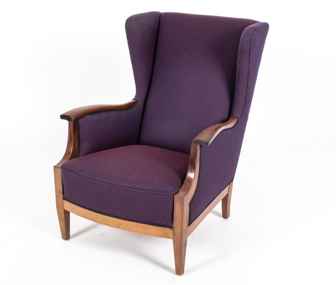 A handsome Danish mid-century wingback chair, designed by furniture maker and designer Frits Henningsen (1889–1965), c. 1940's. Both the proprietor of a furniture-making workshop with a team of cabinetmakers in central Copenhagen as well as the