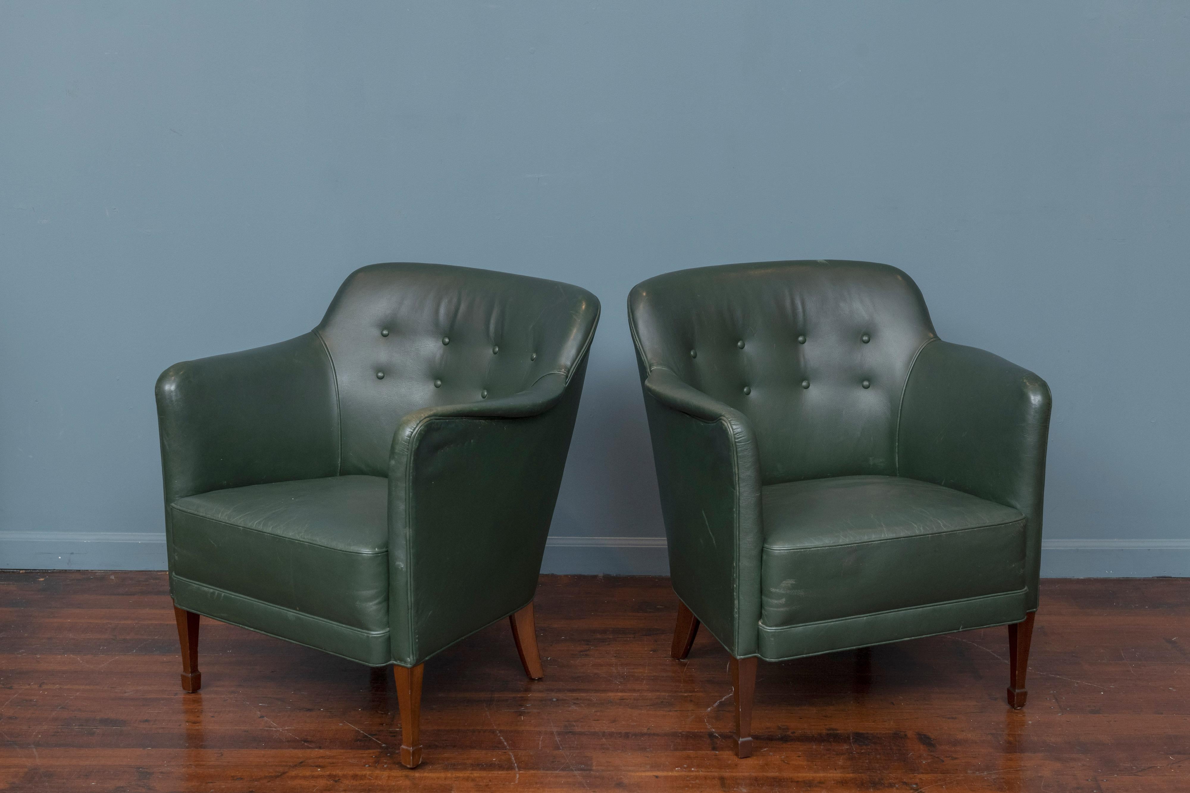 Frits Henningsen style lounge chairs executed in green button tufted leather on mahogany legs. Original leather upholstery is in good usable condition, ready to be installed.