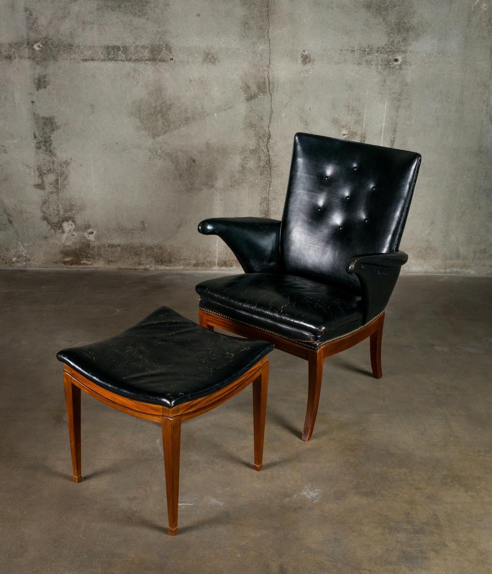 A Frits Henningsen lounge chair and ottoman, in leather and mahogany.  From Denmark, 1930.

Dimensions listed are for the chair. Ottoman dimensions: 18