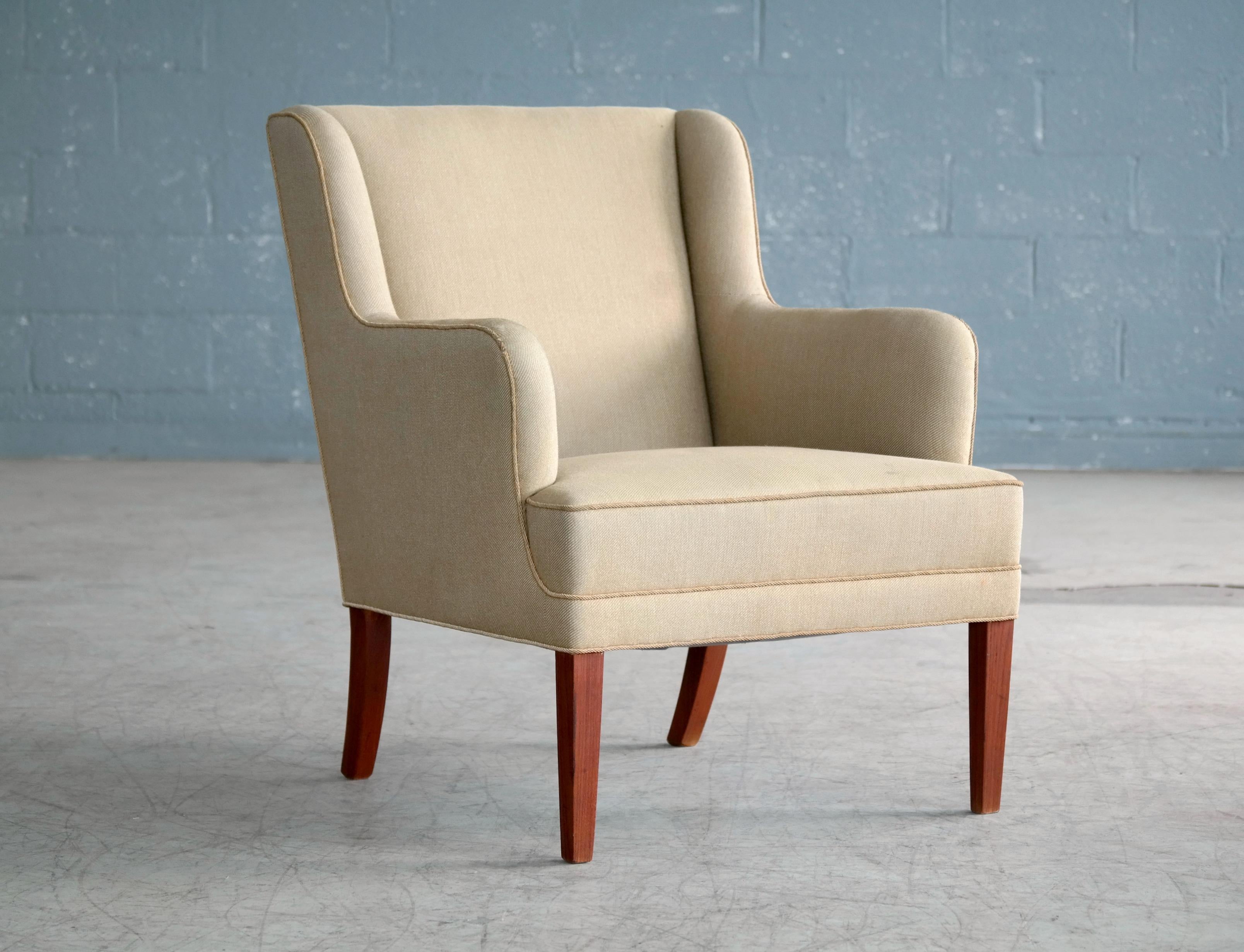 Classic Frits Henningsen lounge chair made in Denmark, circa 1950. Frits Henningsen's elegant and modern style go equally well in very modern environments or with something more traditional which is a main reason they are so sought after. This chair