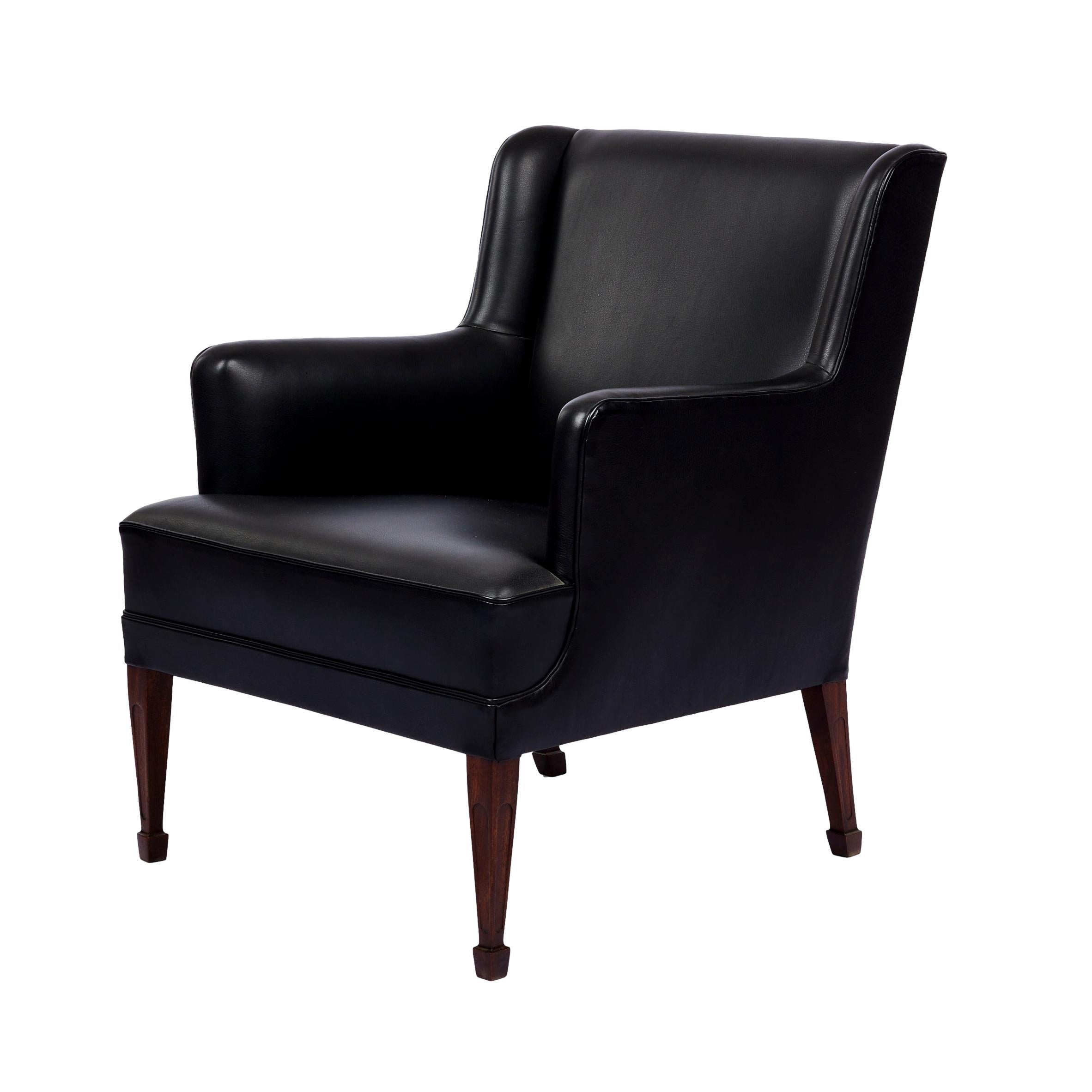 Frits Henningsen lounge chair. Legs are Mahogany. New black leather. From 1940's.
      
