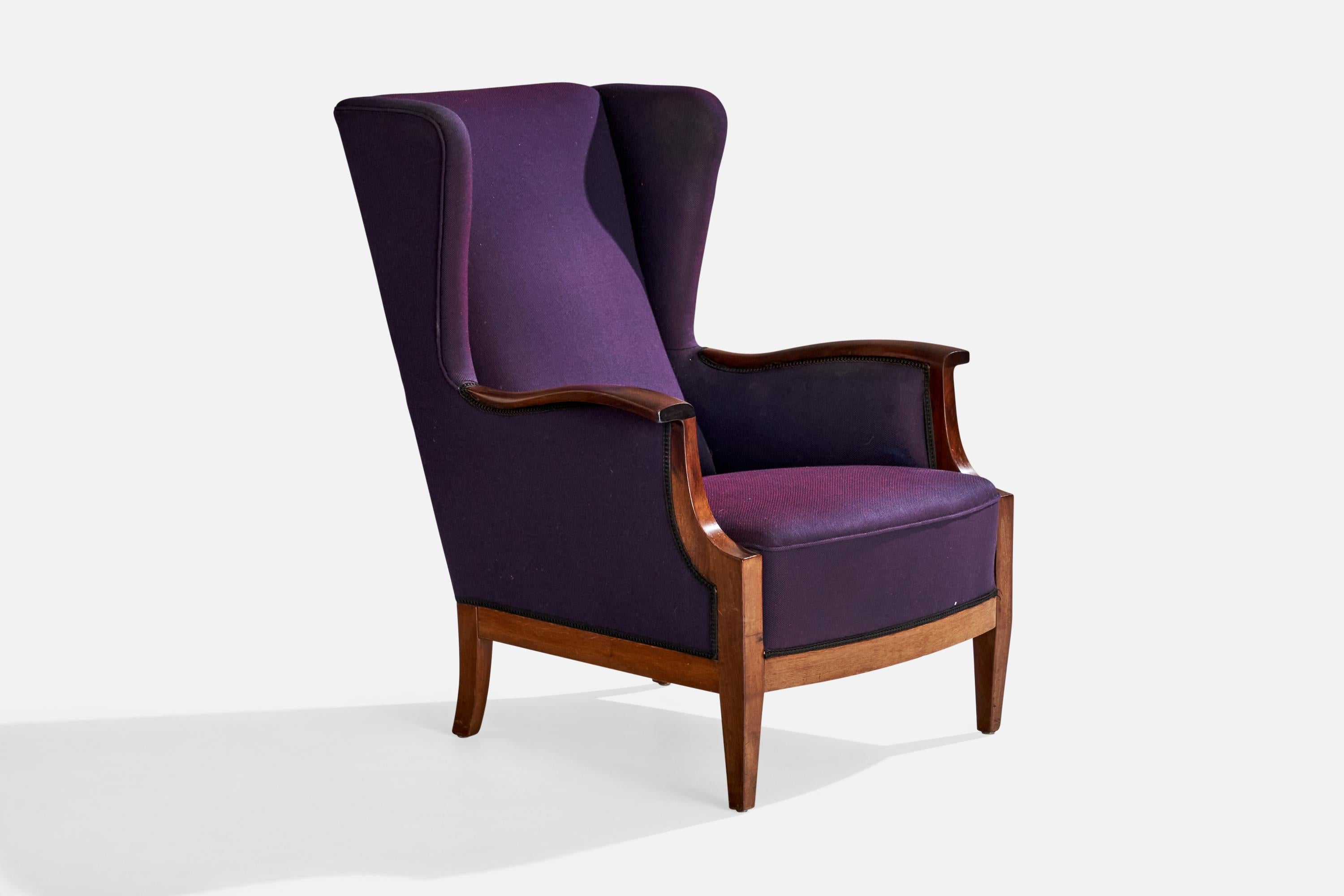 A mahogany and purple fabric lounge chair designed and produced by Frits Henningsen, Denmark, c. 1940s.

Dimensions: 37.25” H x 29” W x 36” D

Seat height: 16.5”