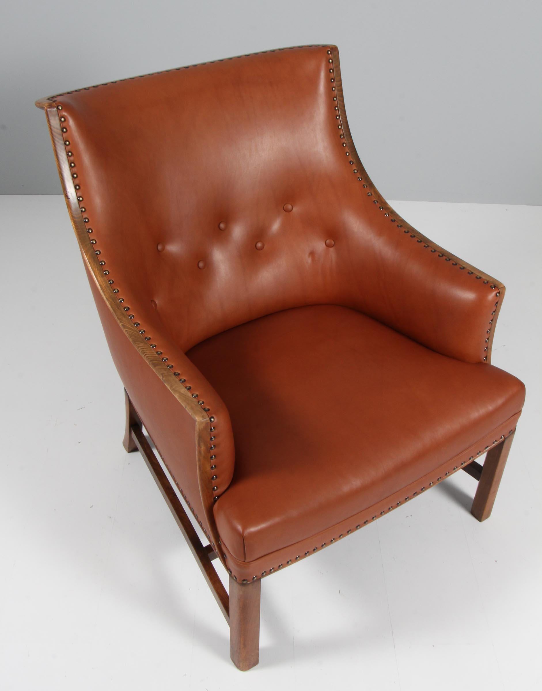 Frits Henningsen lounge chair new upholstered with brandy coloured aniline leather.

Frame of mahogany. 

Made in the 1940s.