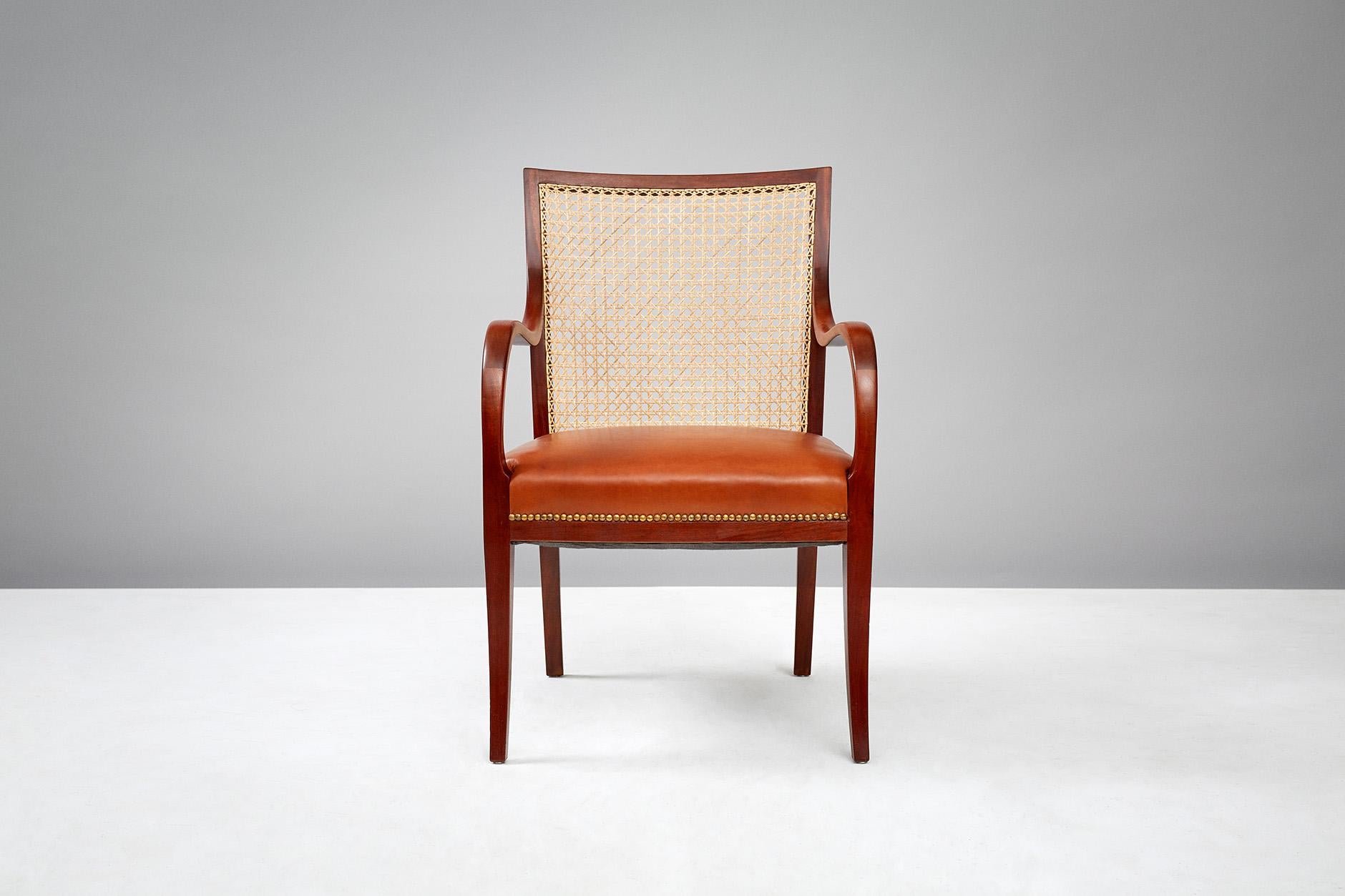 Frits Henningsen

Pair of cane back armchairs, circa 1940s

This pair of Cuban mahogany armchairs designed and built by master Danish cabinet maker Frits Henningsen. The chairs features traditional blind French cane backs, cognac brown aniline