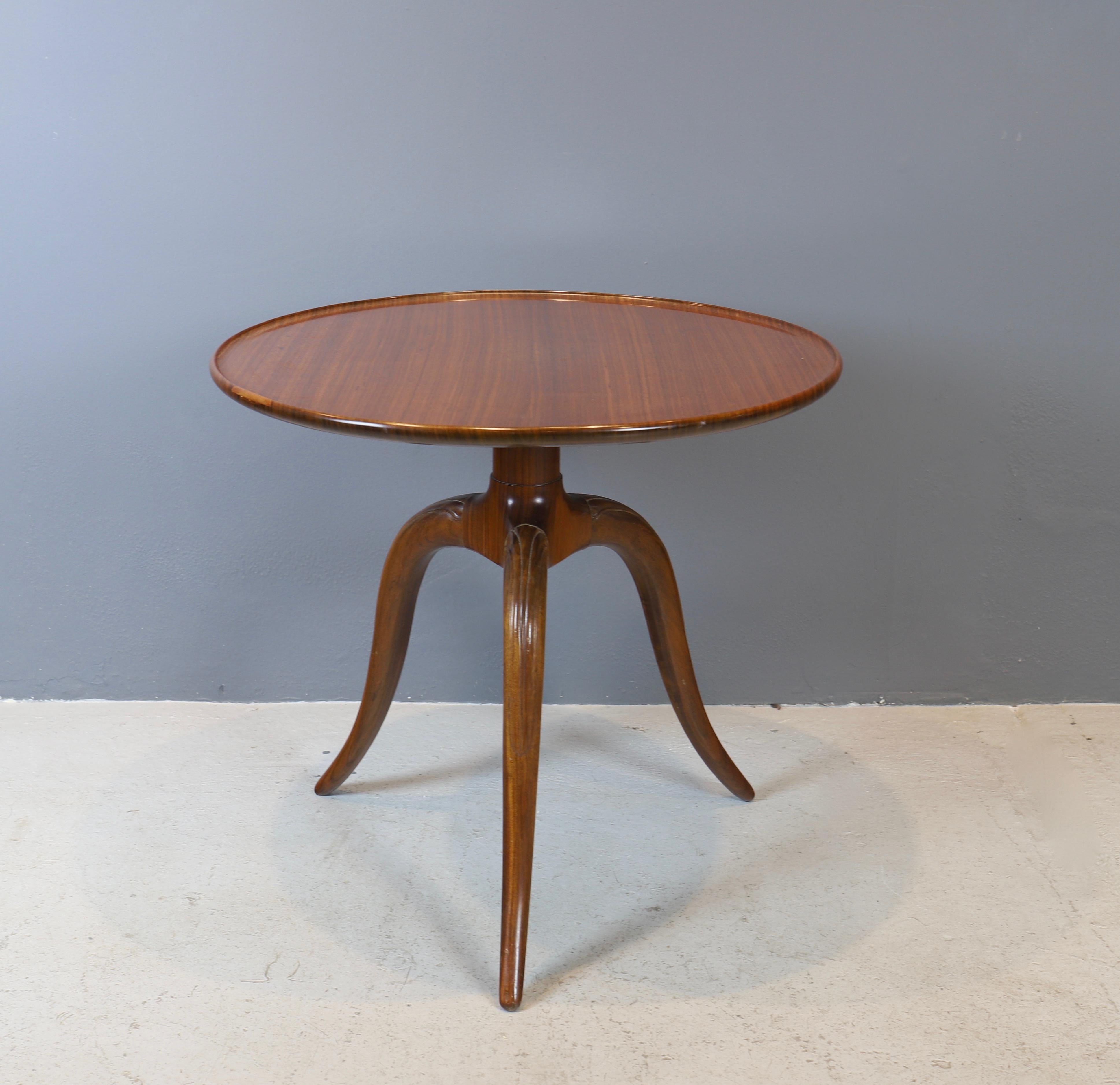 Circular, light mahogany side table by Frits Henningsen, circa 1940s.
Solid round top is supported by a column and three gently curved legs.
Incredible craftsmanship and detail.
Table is in beautiful original condition with warm patina.