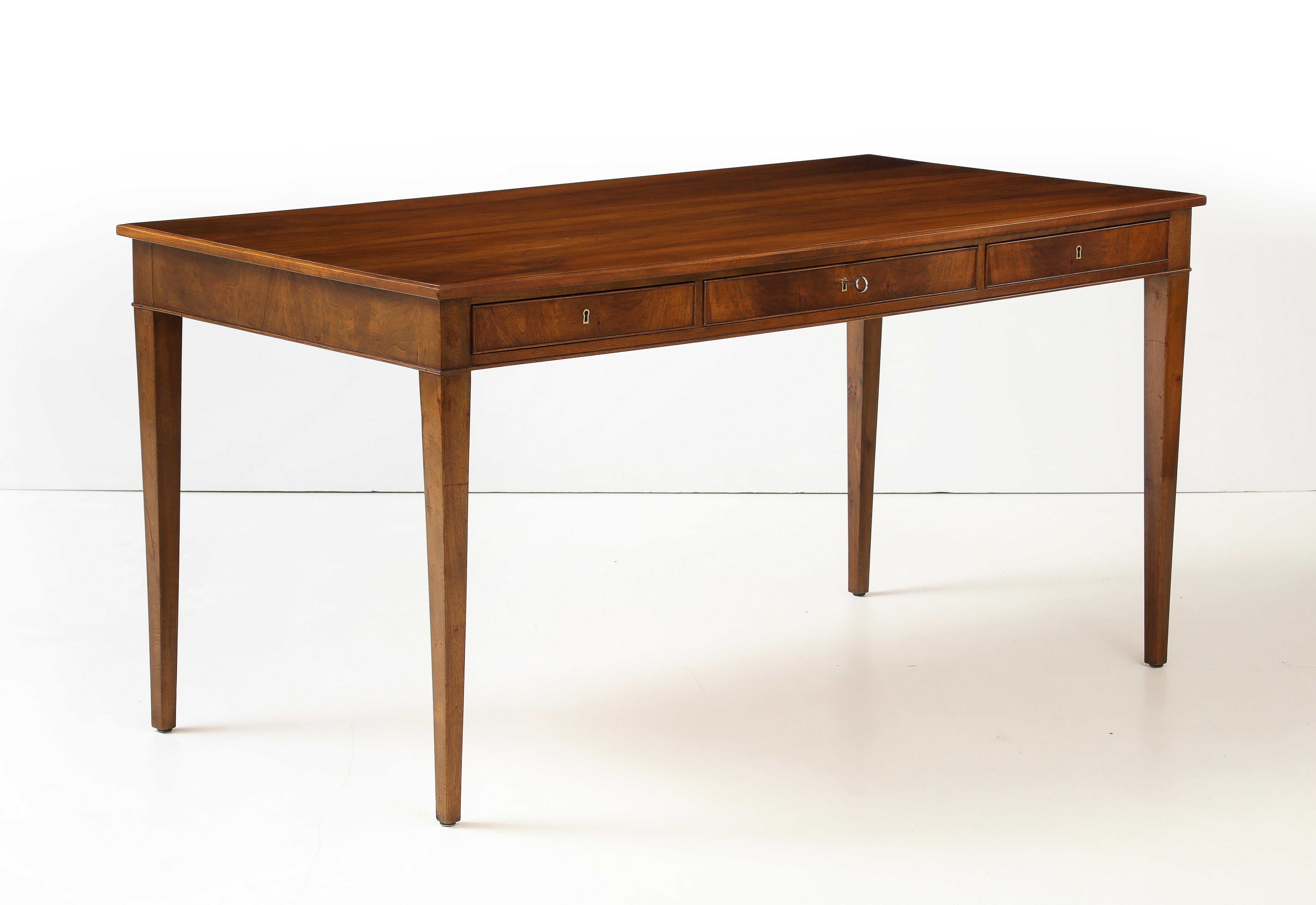 A Danish mahogany writing table by Frits Henningsen, furniture designer and cabinet maker (1889-1965). This desk is a classic example of Henningsen's elegant clean lines and use of quality woods with perfect balanced craftsmanship. A rectangular top