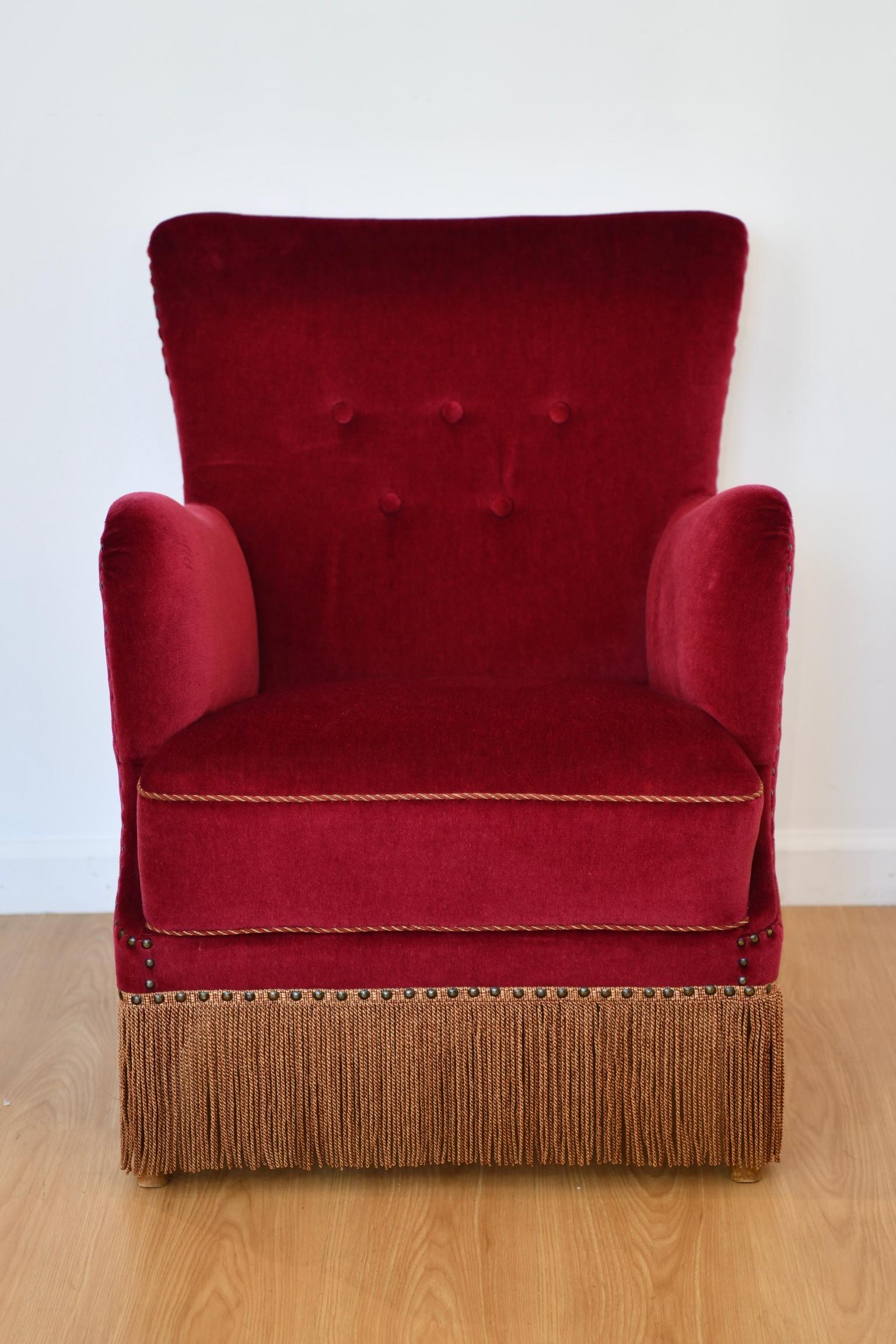 Danish mid-century lounge chair in rich red mohair velvet, with corded fringe trim and beechwood legs in the manner of Frits Henningsen. Apparently unsigned, circa 1940's-1950's. Dimensions: 31