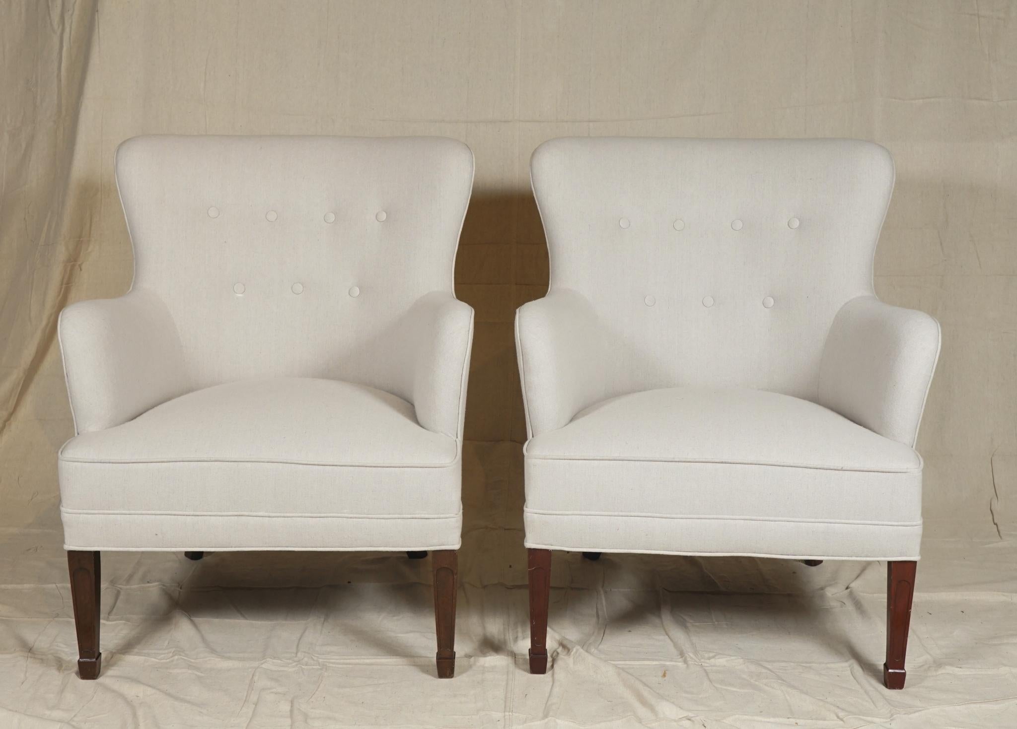 An elegant sofa and pair of matching armchairs by Danish designer Frits Henningsen
(sofa 31 H, 29 D, 54 W, 29 D, chairs 31 H, 26 W, 29 D, 16 SH)

Frits Henningsen (1889–1965) was a Danish furniture designer and cabinet maker who achieved high