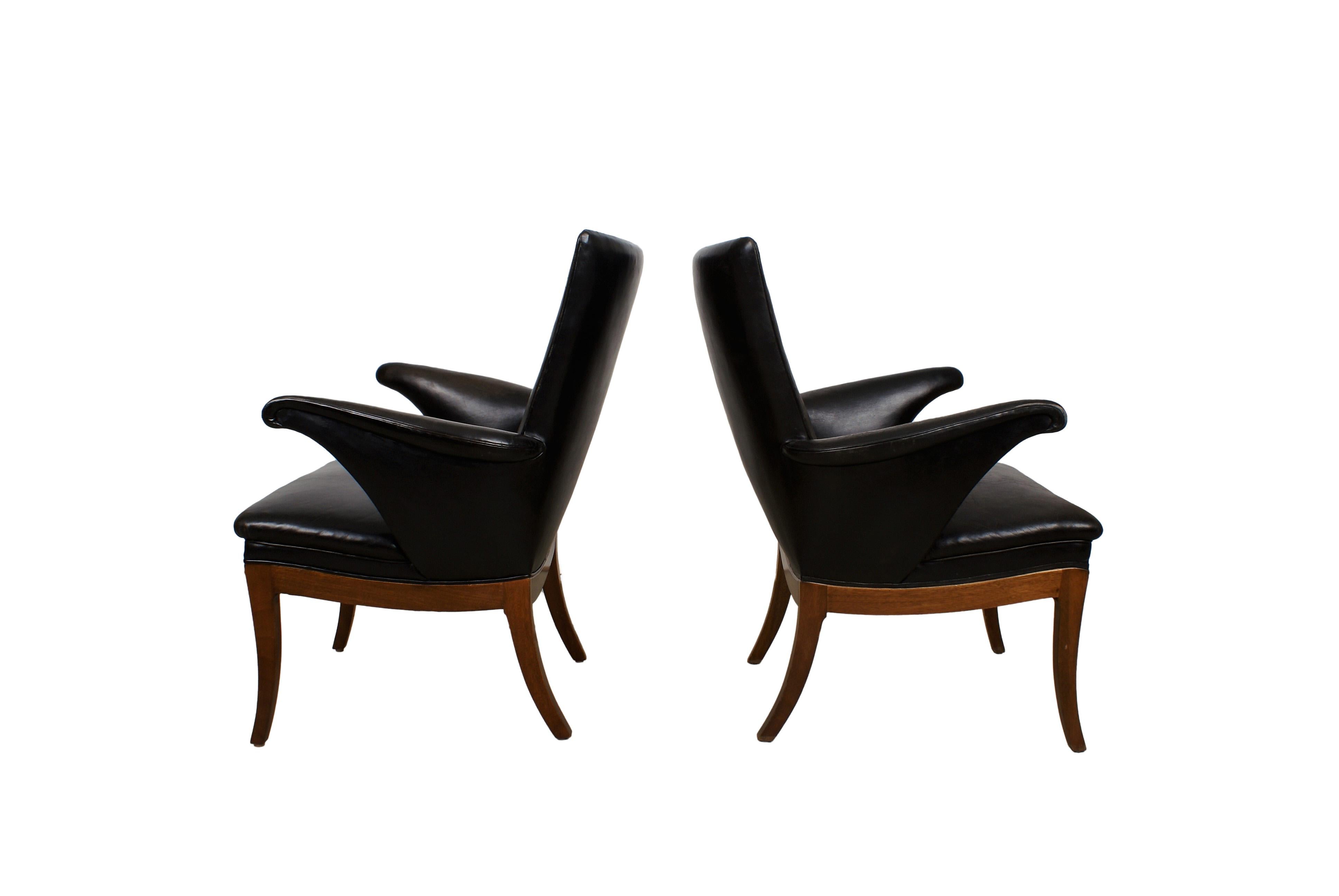 Frits Henningsen, pair of Cuban mahogany armchairs with curved armrests and legs. Sides, seat and back upholstered with patinated original black leather, fitted with brass nails. Back with leather covered buttons. Designed 1932. Made by cabinetmaker